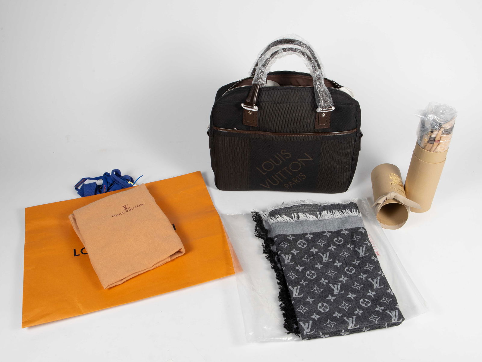 Lot: Louis Vuitton Bag & Shawl & Burberry Scarf.: The lot contains 3 luxury items. First, there is a Louis Vuitton Damier Geant Yak business messenger bag in black canvas with dark brown leather details. It measures 15" x 11" x 4", appears unworn, an
