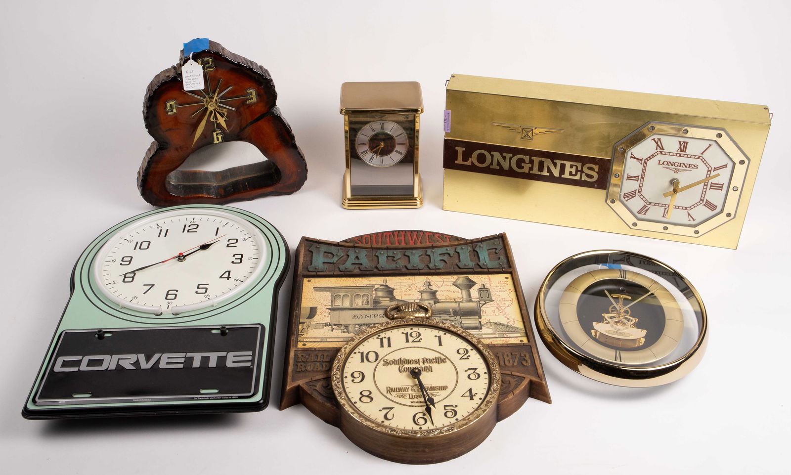 6 Vintage Clocks- Dealer Advertising Clocks, etc.: These items are untested. Included are the following: a Longines dealer clock, a Southwest Pacific Company wall clock, a neon Corvette clock, a Seiko oval wall clock, a wood slab wall clock, and a Sli