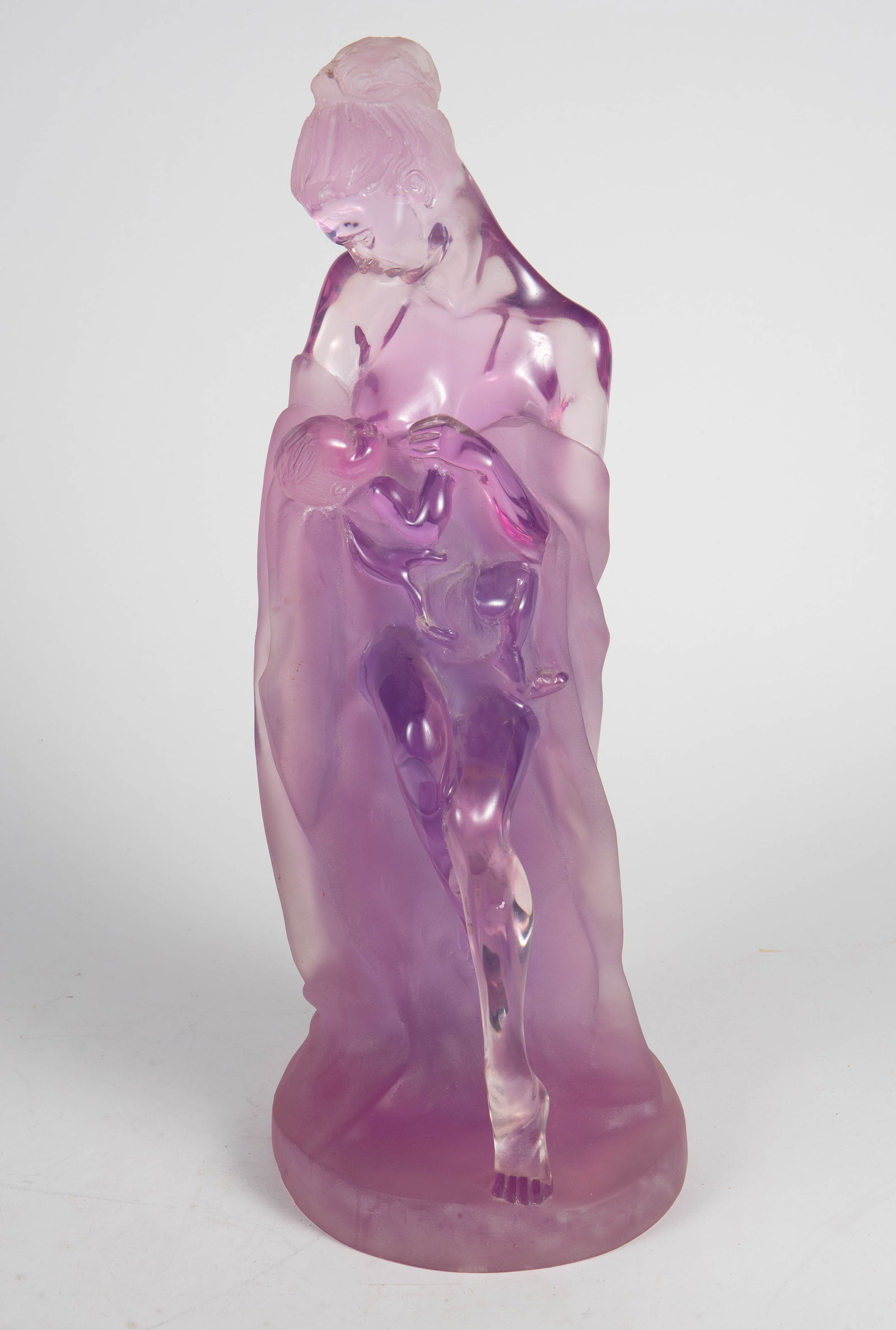 J. Boiros Signed Acrylic Sculpture- Mother & Child: It is an amethyst-colored sculpture of a woman about to breastfeed her baby. Overall, it looks to be in good condition. It measures 9" x 9 1/2" x 25 1/4". Third-party shipping or personal pickup is re