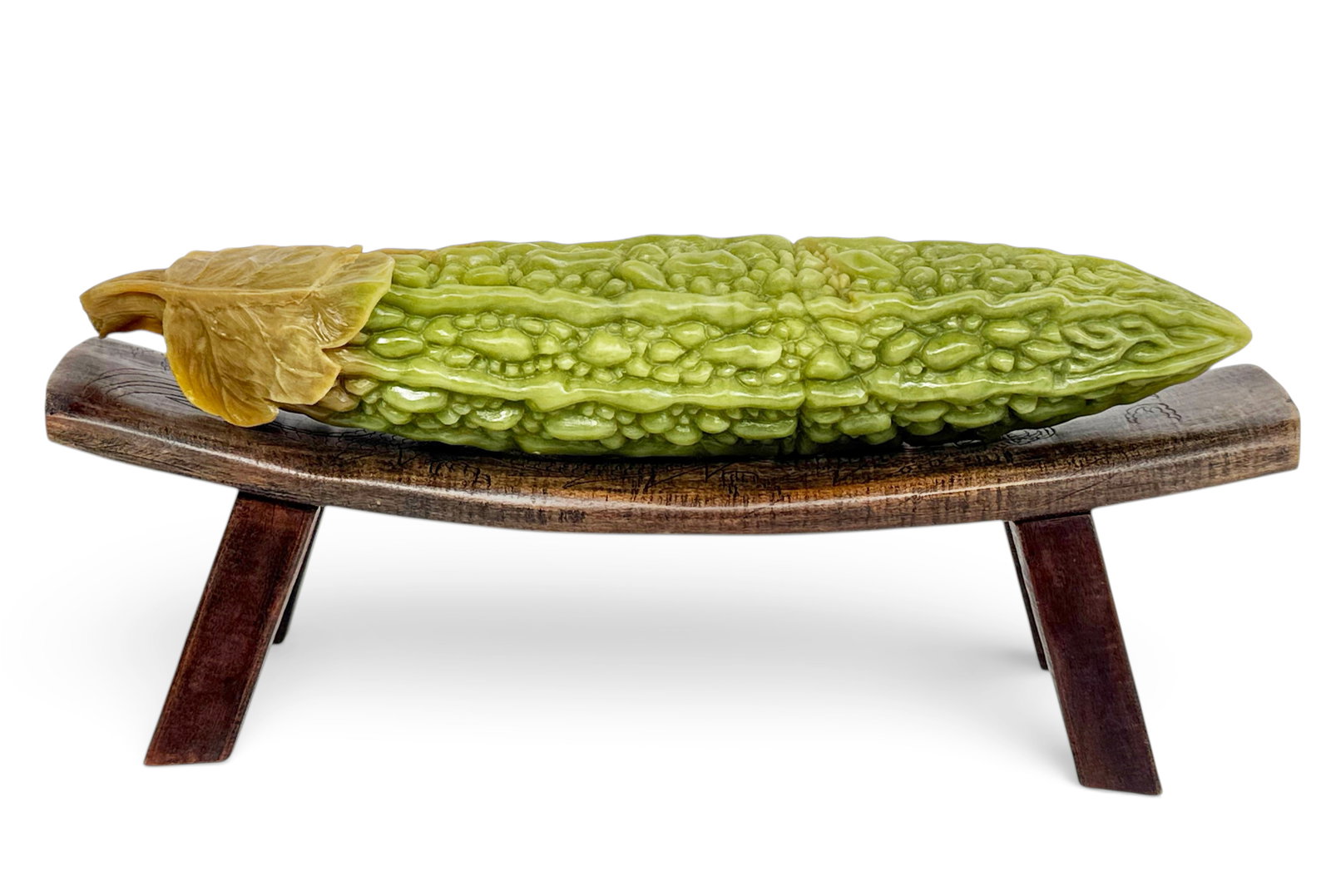 Chinese Carved Soapstone Bitter Melon & Wood Stand: The bitter melon comes with a wood stand with a dragon design on the stand. Both pieces look to be in good overall condition. The bitter melon measures 2 1/8" tall, 11 3/8" wide, and 2 1/4" deep. The