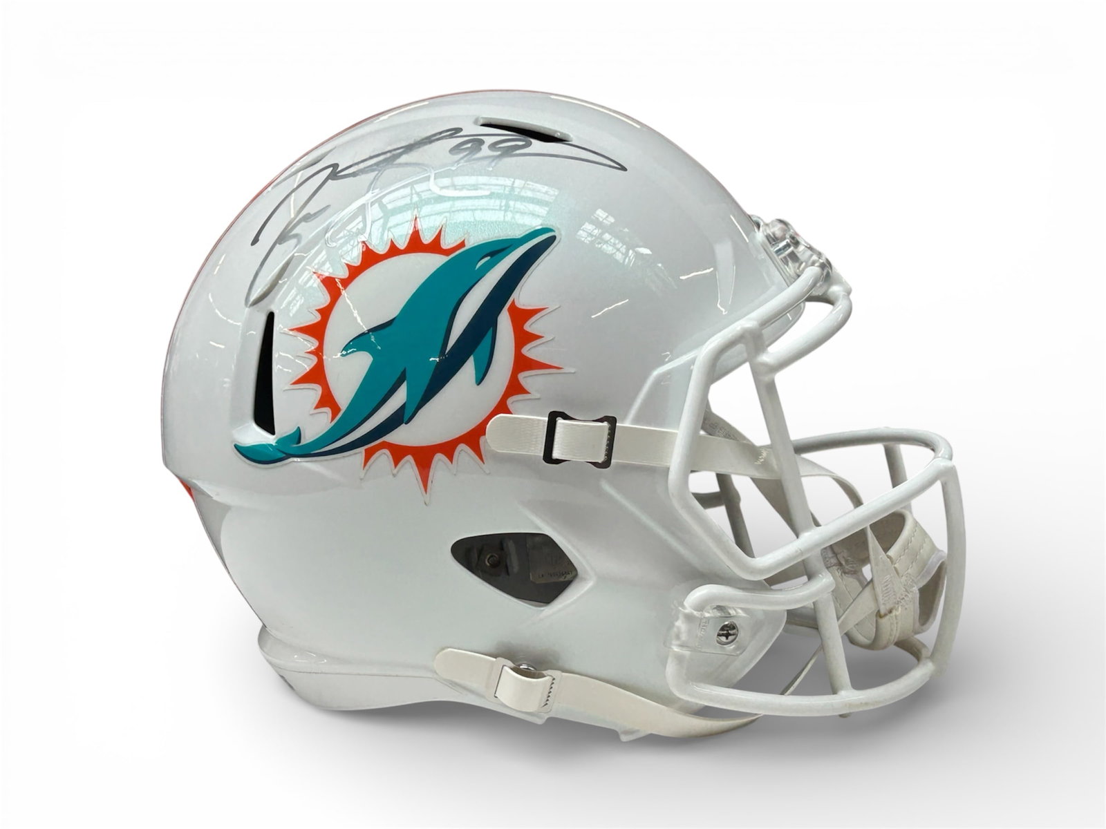 Jason Taylor #99 Autographed Dolphins Repro Helmet: The lot contains a Miami Dolphins Riddell full sized replica helmet bearing the autograph of defensive end player #99 Jason Taylor in silver ink. The autograph is not authenticated. The helmet measure