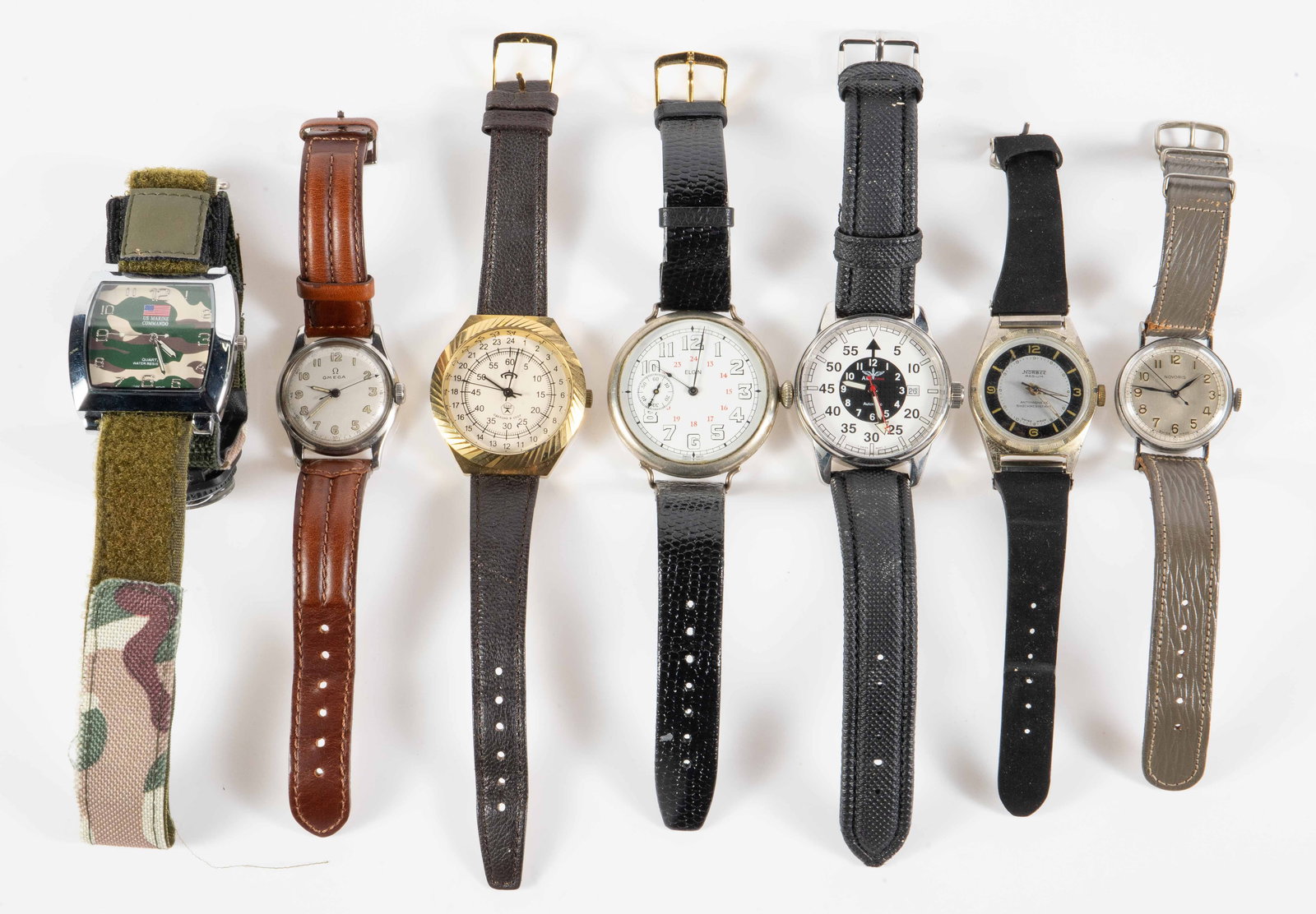 7 Mostly Military Watches - Omega, Elgin, Novoris.: The lot contains 7 mens' watches, including several antique or vintage pieces from WWI and WWII. The watches included are Norbee Radium, Norvis, Omega (Engraved Mizpah), Elgin trench watch, Soviet Rak