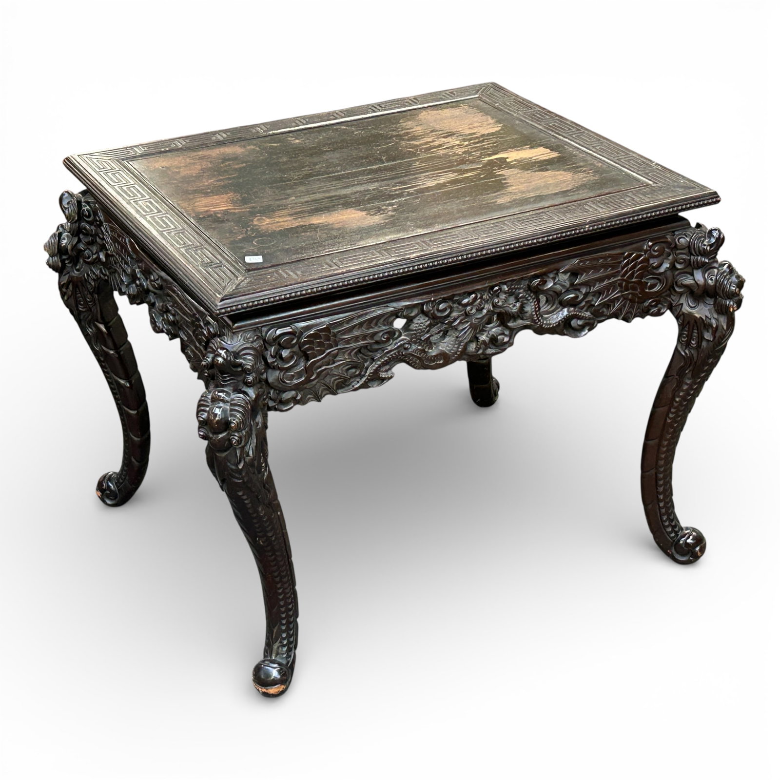 Antique Japanese Carved Dragon Table.: The dark wood table has intricate carvings of dragons and floral details on the apron and curved legs. The surface border has a geometric design and lower beaded carvings. It measures 28 1/2" x 36" x