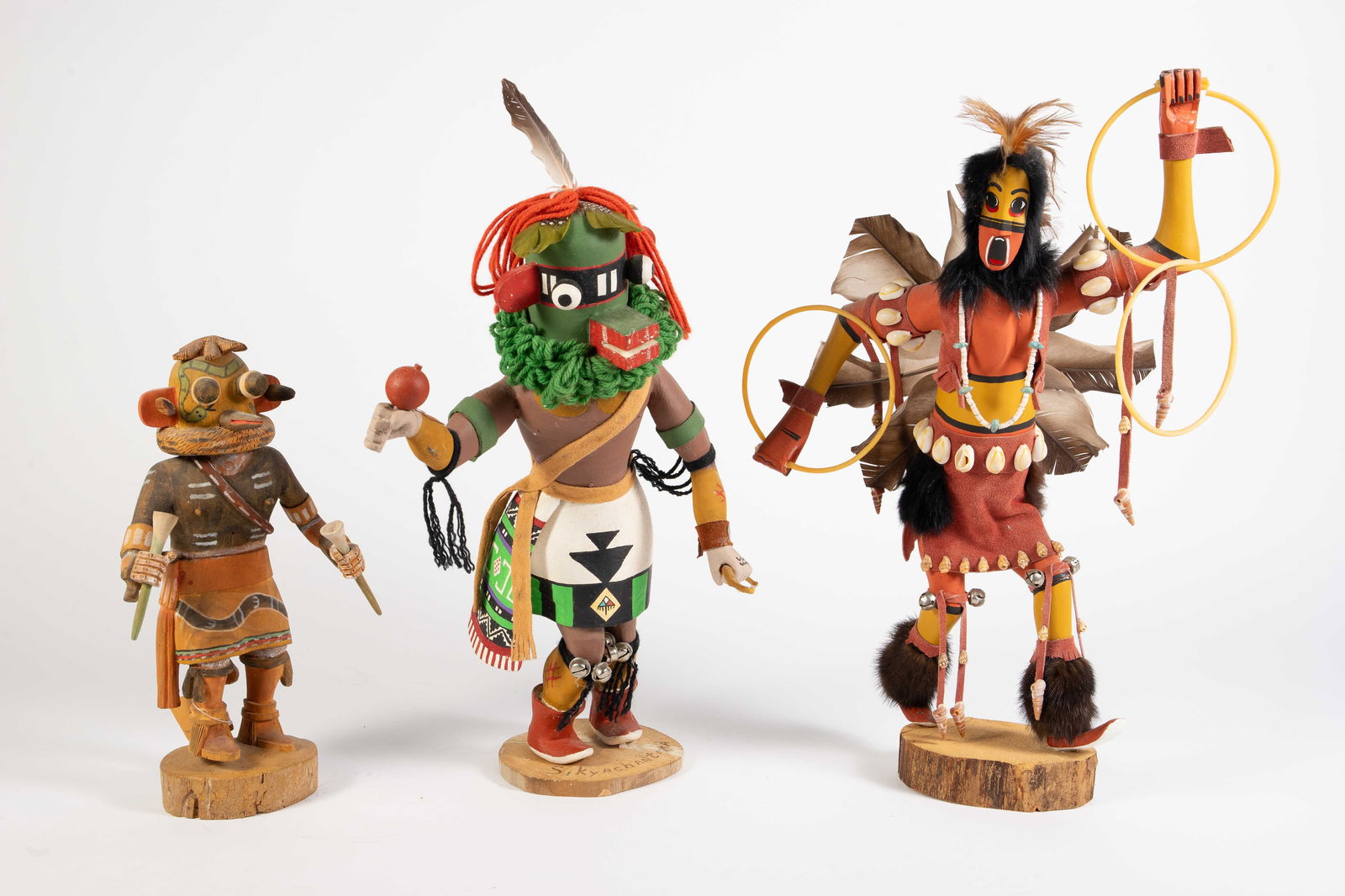 Lot of 3 Signed American Indian Kachina Dolls.: One is signed, "Hoop Dancer" with an illegible signature. It measures 13 1/2" x 4 1/4" x 19 3/4". Another is signed, "Zuni Rattle Snake" by Everett Tawahongva. It measures 8" x 4" x 13". The last one