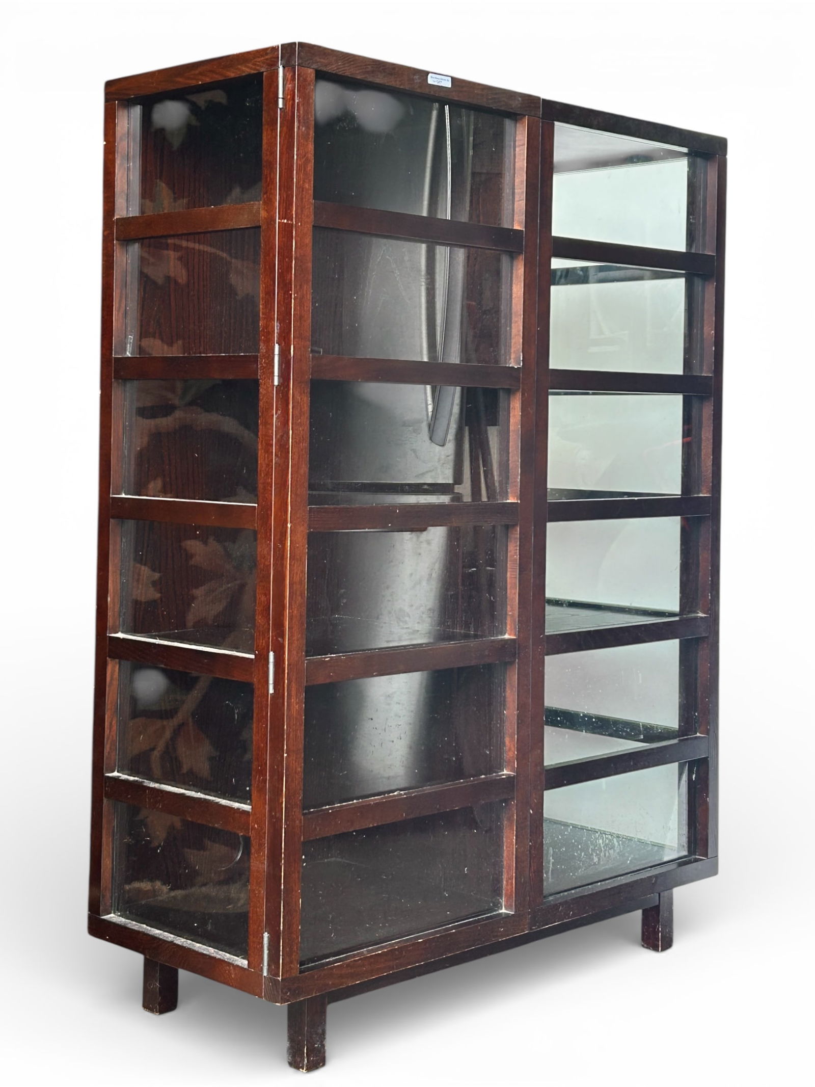 Crate & Barrel Bookcase.: This bookcase or cabinet has two glass panelled doors and glass sides. Each side has two fixed interior shelves. There are some scratches and indentations. It measures 38" wide, 16" deep, and 52 1/2"