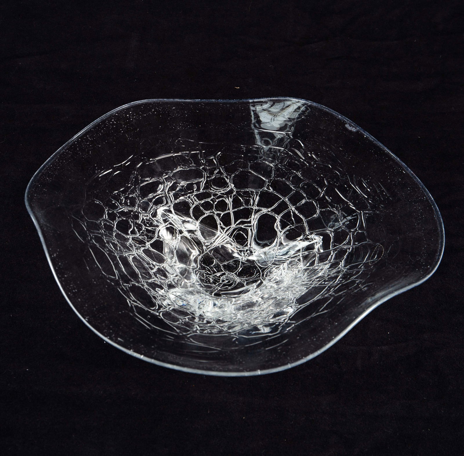 Signed Freeform Clear Glass Bowl w/ Wavy Rim.: The signature underneath is quite difficult to read. The wavy bowl has a pattern that resembles cracking ice. Overall, it looks to be in nice condition. The dimensions are 13 1/2" x 13" x 4 1/2". In-h