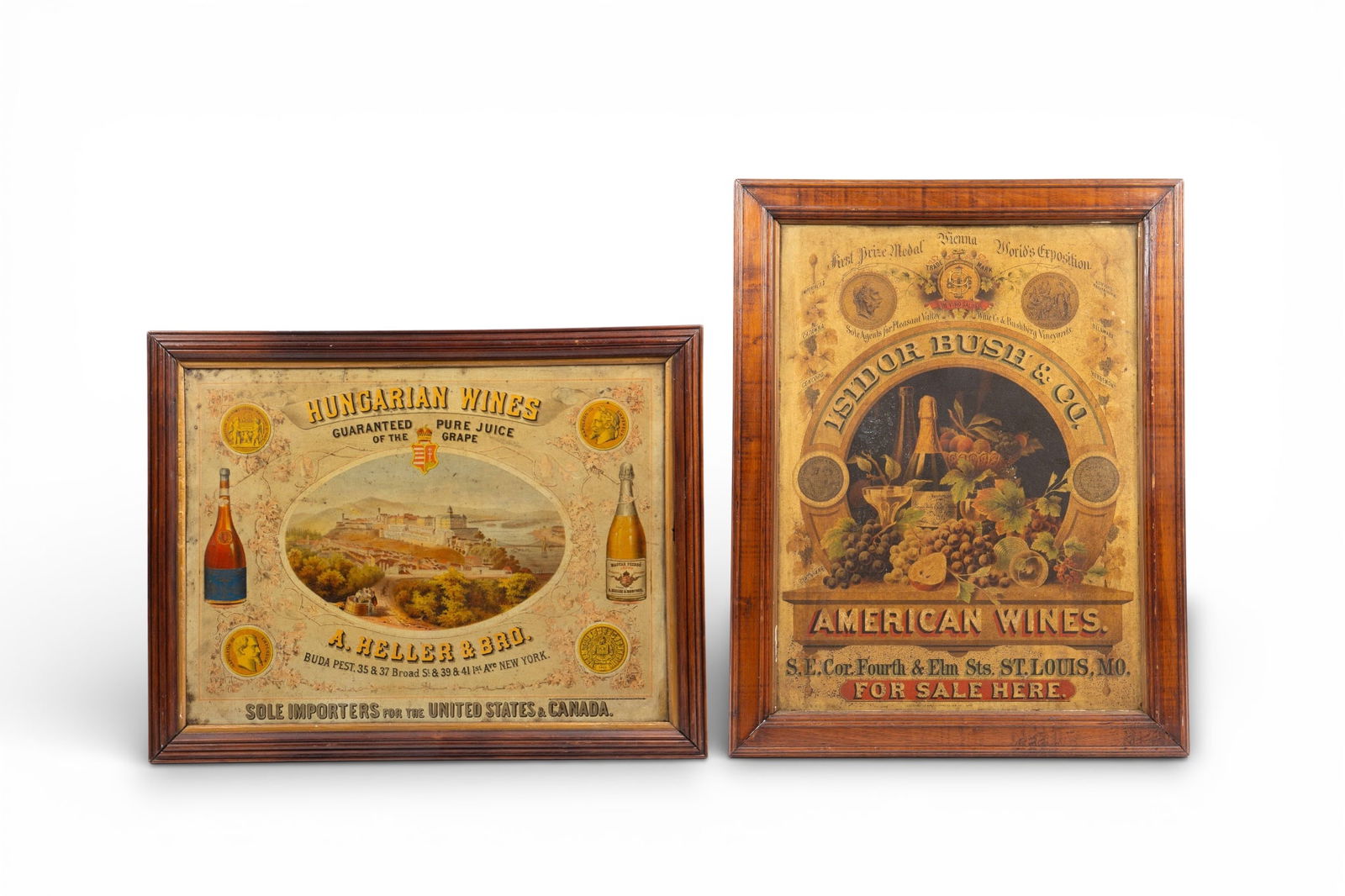 2 Antique Tin Wine Advertising Posters, Framed.: The lot contains 2 framed antique metal wine advertisements. The first one is for Isidor Bush & Co. American Wines, and the second is for Hungarian Wines A Heller & Brother. The 2 1/4" thick frames me