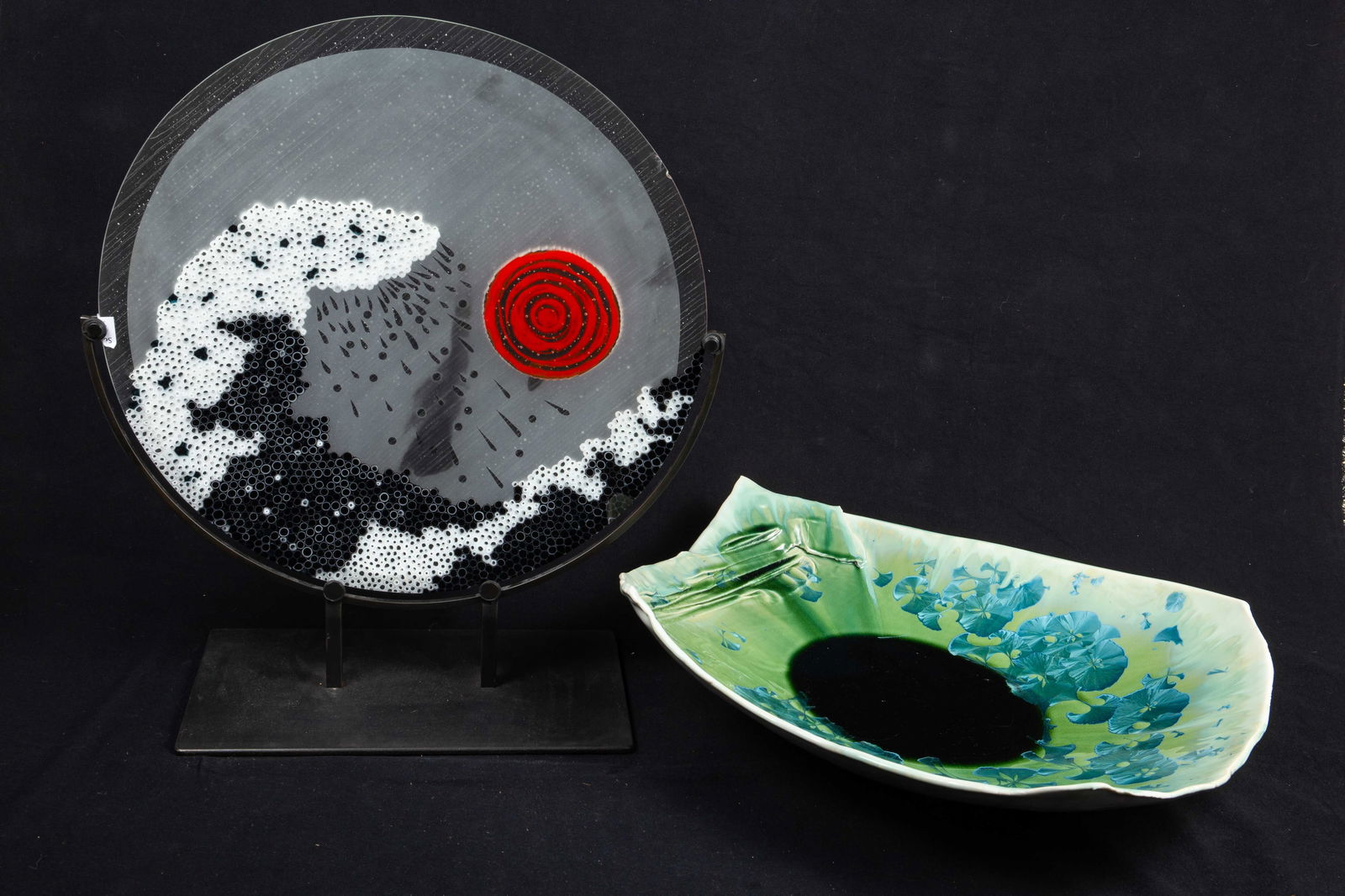 Lot: Gail Jones Pottery, Hegland Glass.: This lot includes a mirrored pottery bowl with gingko leaf motif, and an art glass charger inspired by Hokusai's "The Great Wave Off Kanagawa". The pottery bowl is signed, "Gail Jones". It has some sc