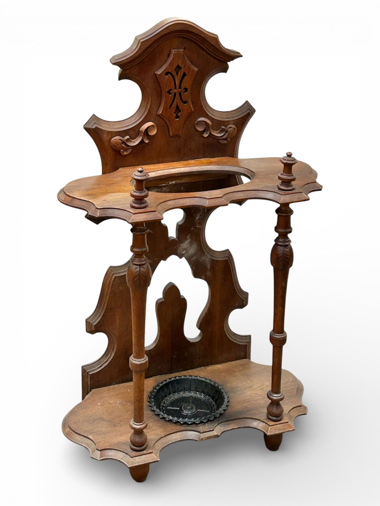 Antique Victorian Umbrella Stand.: This ornate walnut umbrella or cane stand comes with a removable iron basin. There are a few minor splits in the wood, as well as a water ring. Overall, it is in good condition for its age. It