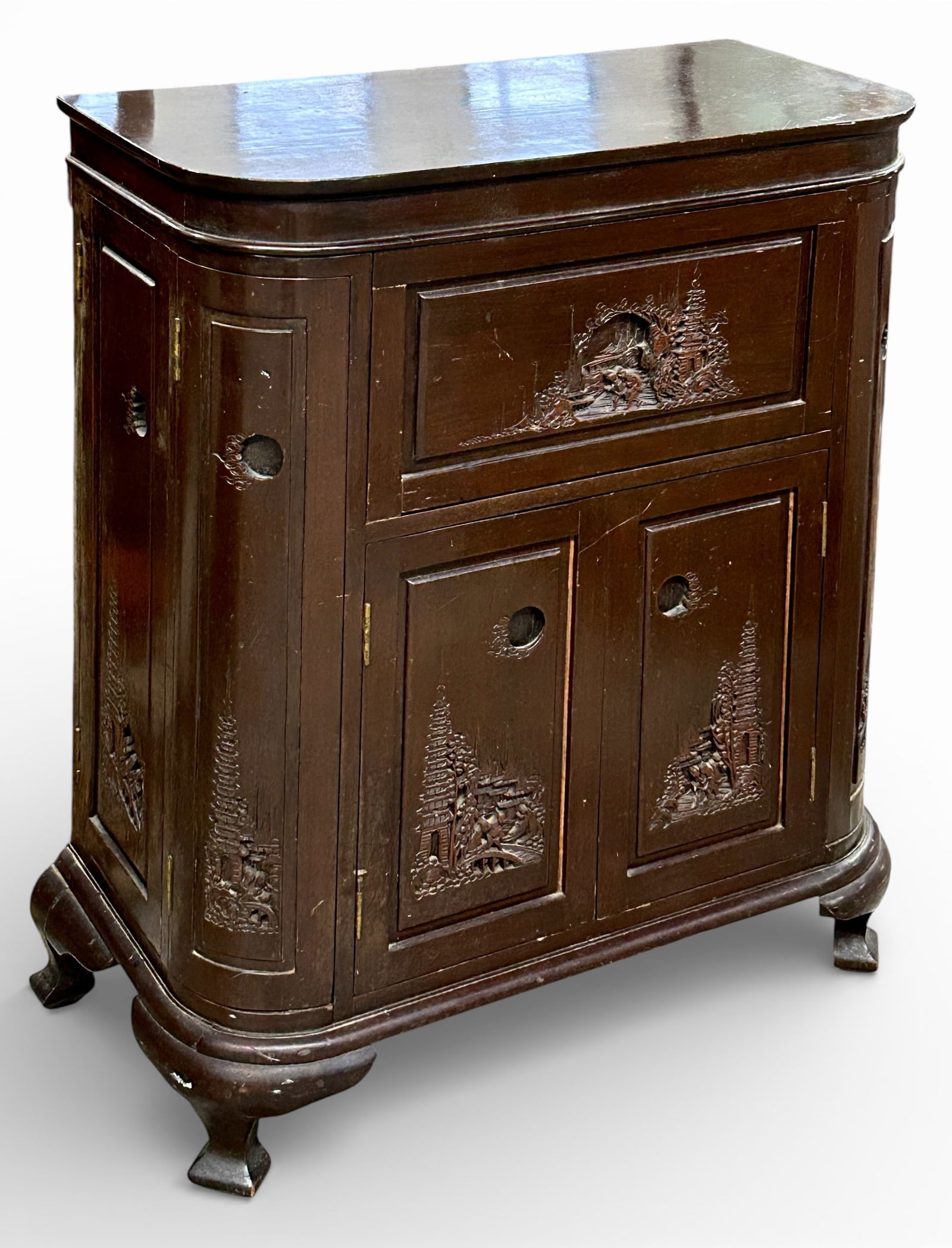 Carved Asian Bar.: This dark wood flip top bar features intricate carvings of figures and scenery. Each side has two side doors with stemware holders and small shelves. The manufacturer's label is attached, and reads,