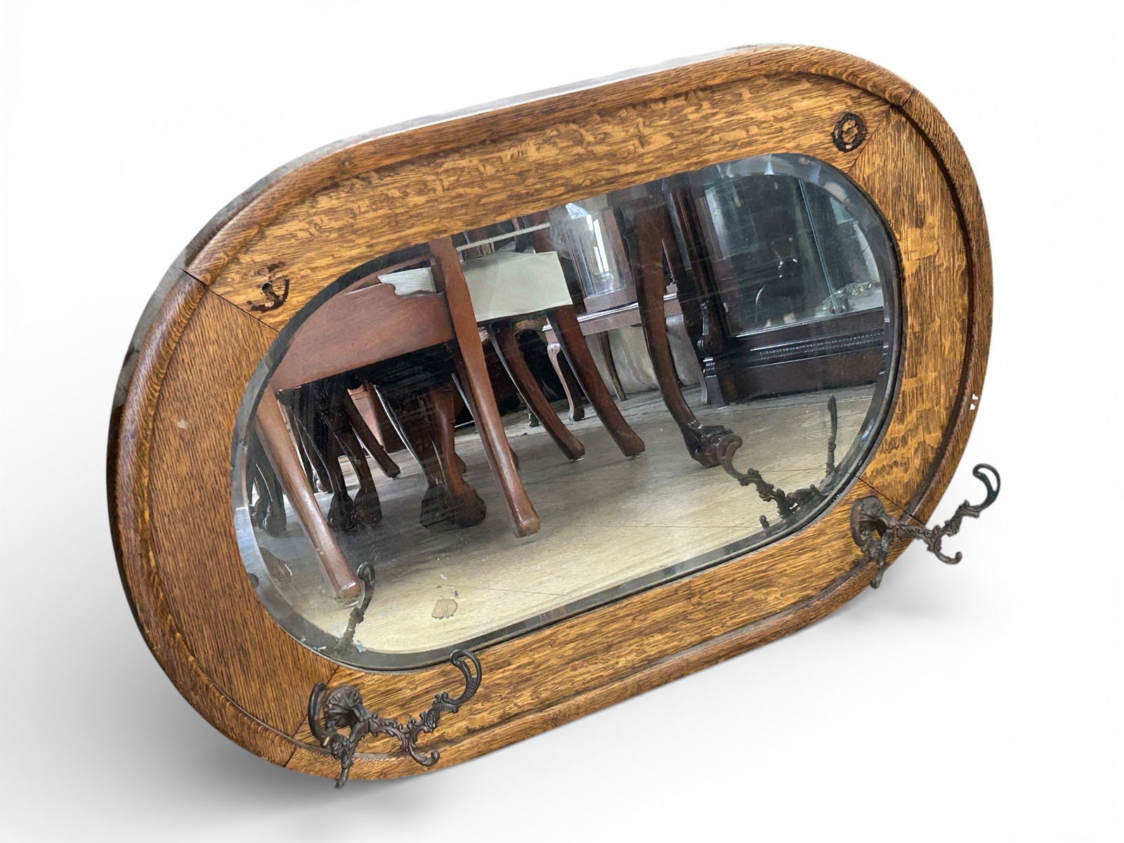 Antique Oak Oval Entryway Mirror w/ Hooks.: This oval mirror has bevelled glass and an oak frame with iron hooks (two of which are missing). A wire is on the back for hanging. There is some desilvering, but otherwise, the mirror is in good