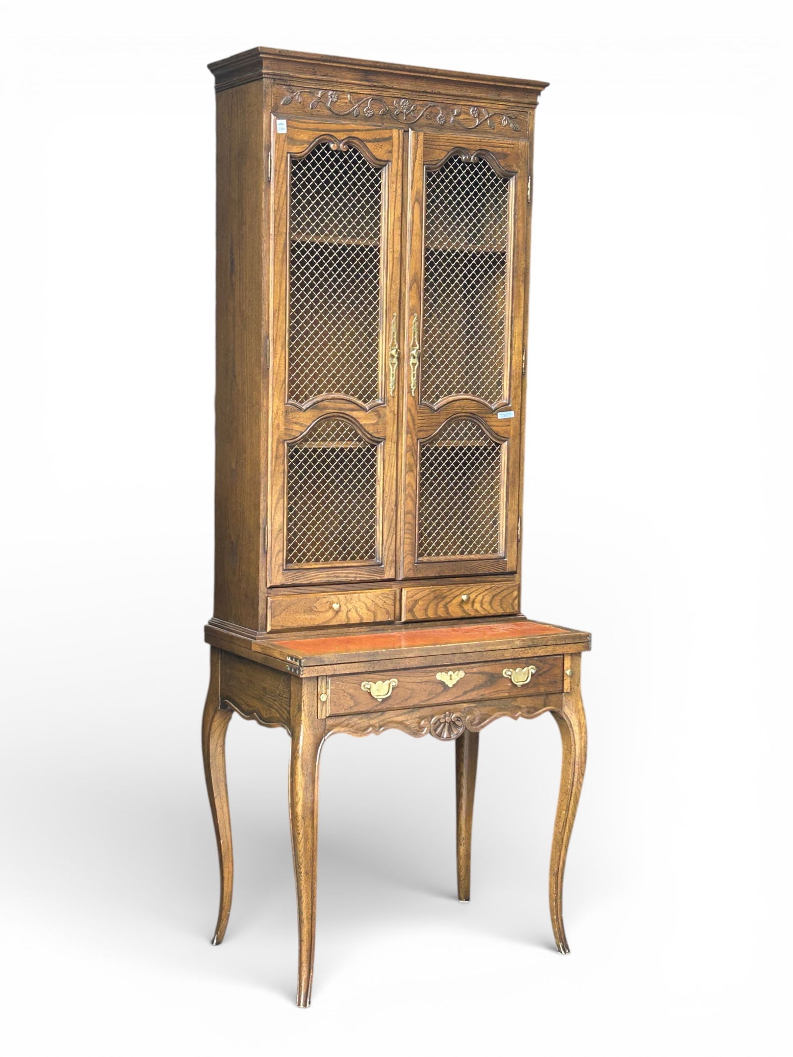 Baker Carved Oak Secretary Desk.: The desktop flips out, and has a leather inset surface. Below the desktop is a single drawer and pull-out supports for the desk. Above the desktop are two small drawers, and a bookcase with