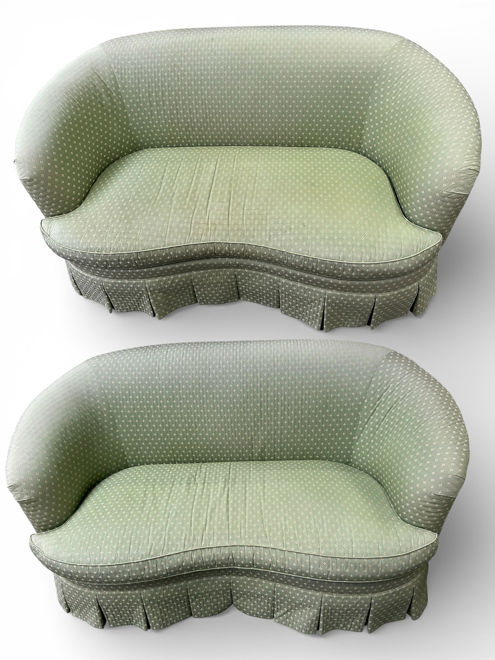 Pair of Vintage Charles Stewart Sofas.: These green upholstered couches are kidney shaped, and have diamond patterns. They are signed, "The Charles Stewart Company - Hickory, N.C." The fabric is sun faded, with a few stains here and there.
