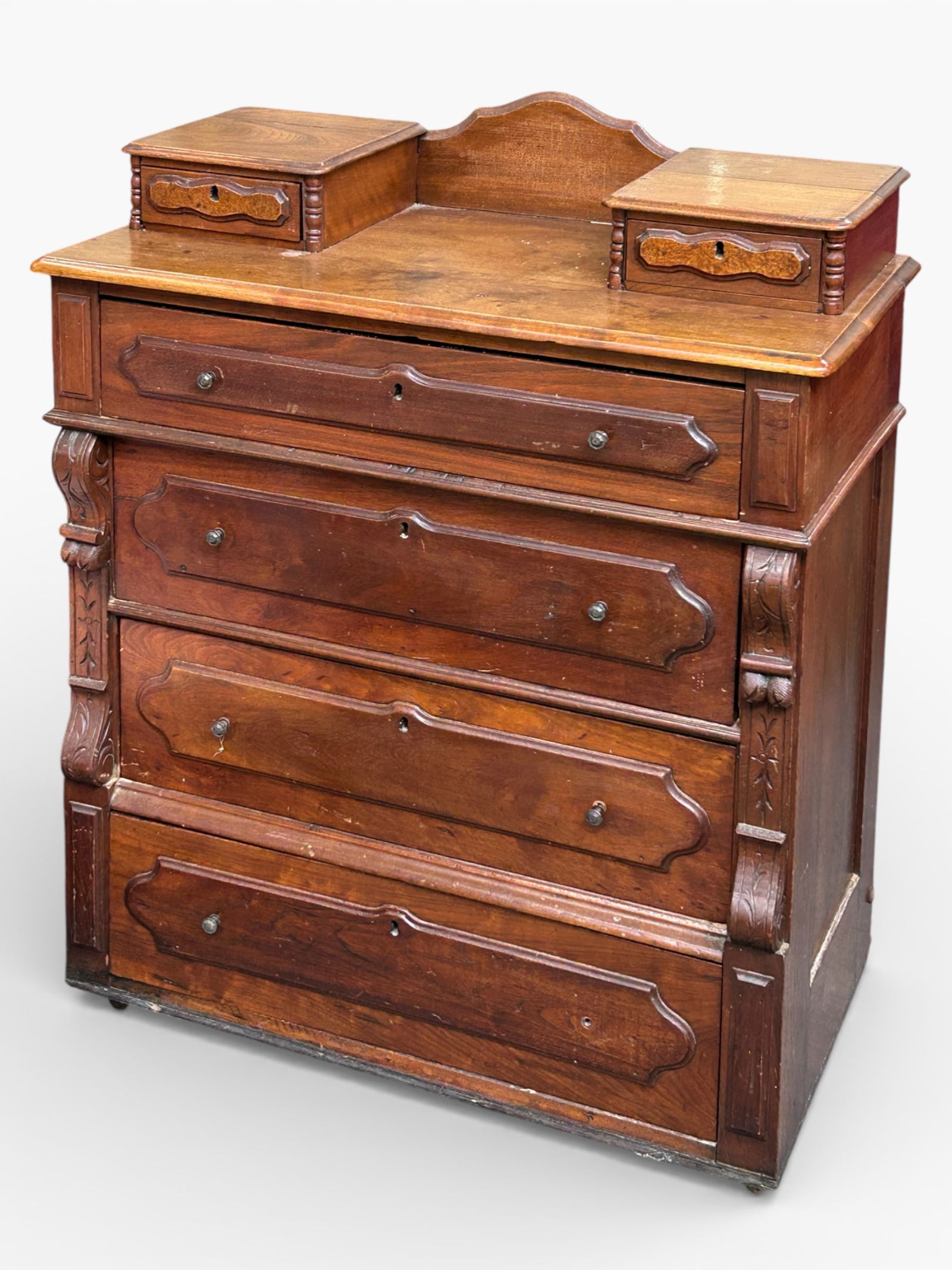 Antique Eastlake Victorian Chest.: This walnut piece has four drawers and two glove boxes. It has multiple carvings, raised moldings, brass hardware, and casters. The top two drawers are missing the lock hardware. A lower drawer is