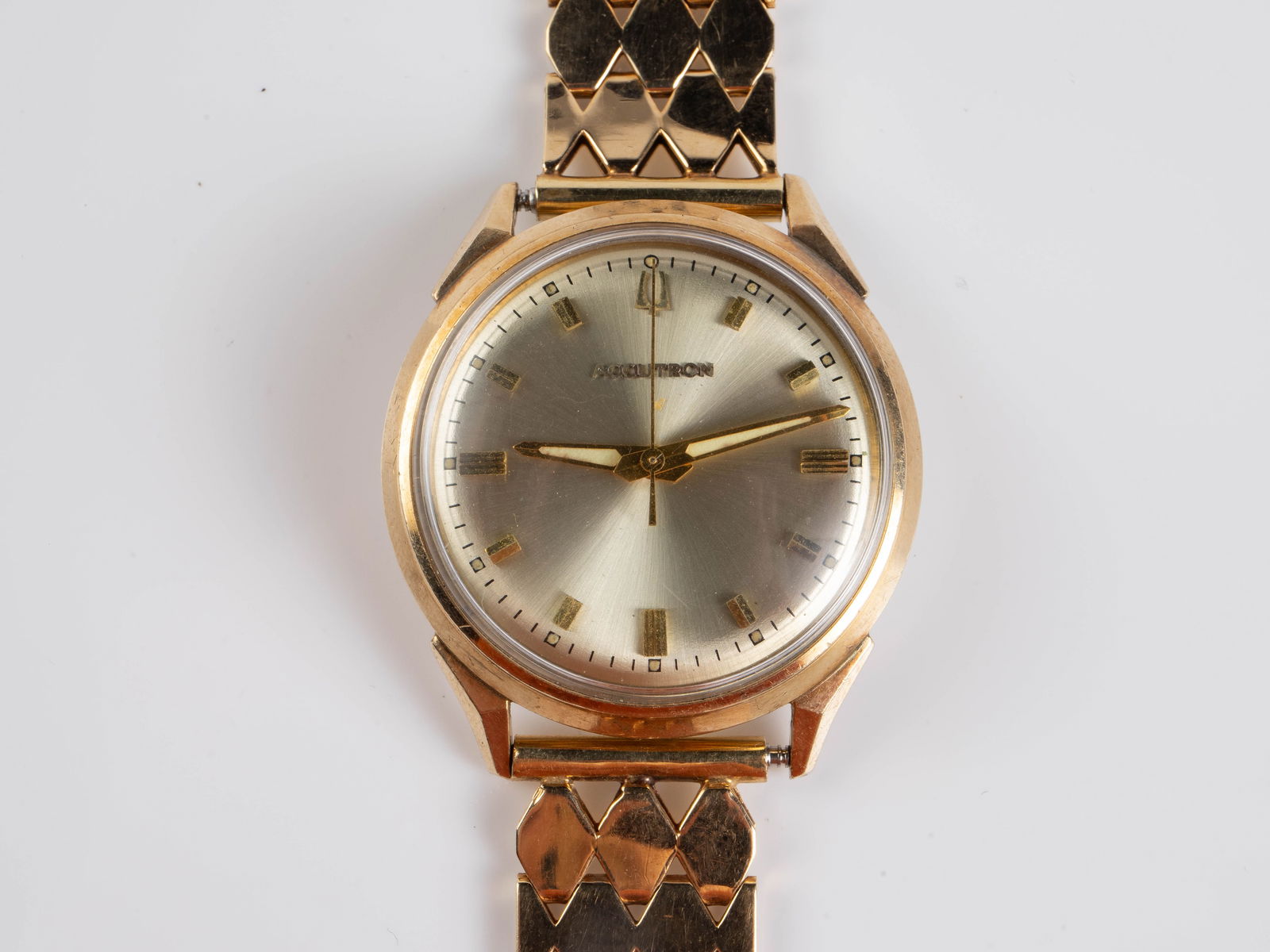 Gold Plate Bulova Accutron Watch w/ 14K Gold Band.: The vintage quartz watch has a 10K rolled gold plate bezel. The band, which is engraved M.G., is marked 14K on the clasp. The watch case measures 33mm in diameter. The watch band portion weighs approx