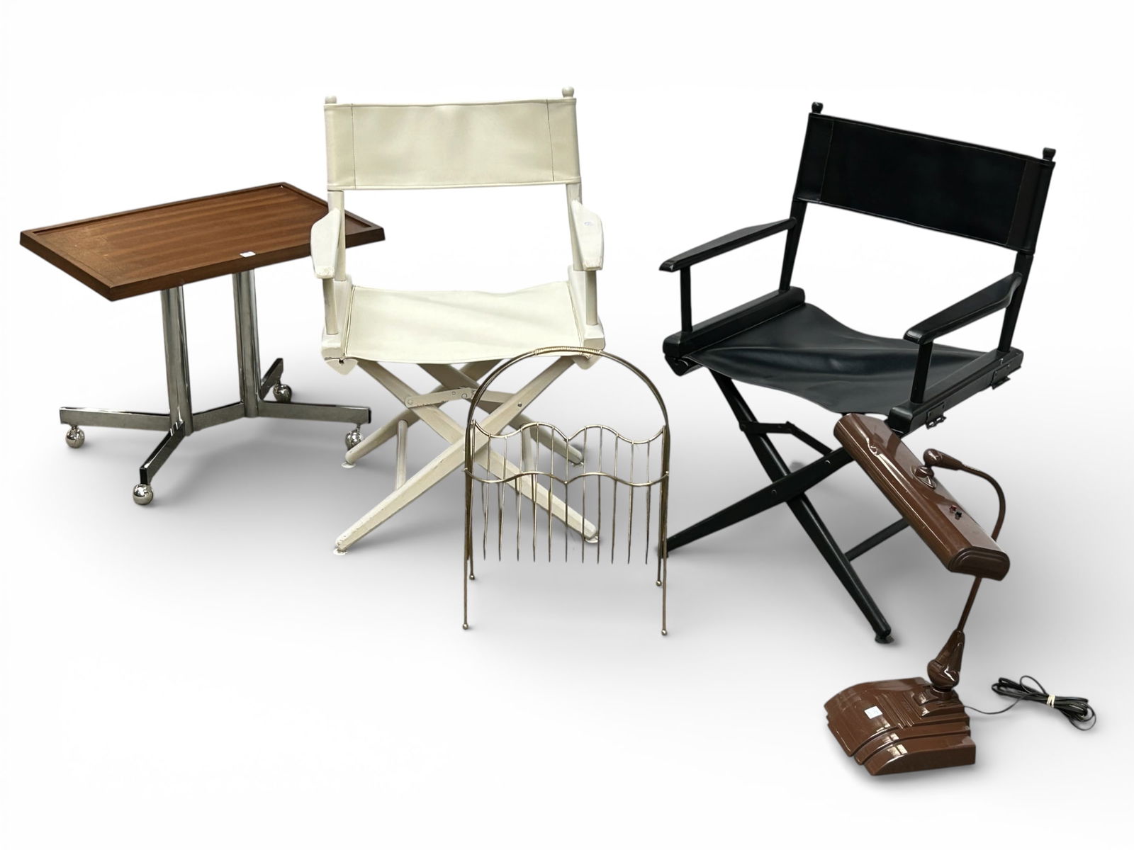 Mid-Century Modern Magazine Rack, Table, & More.: This lot includes two folding director's chairs, a metal magazine rack, a Flexo adjustable desk lamp (working), and a table with a chrome base on casters. Overall, the lot is in good condition. The ta