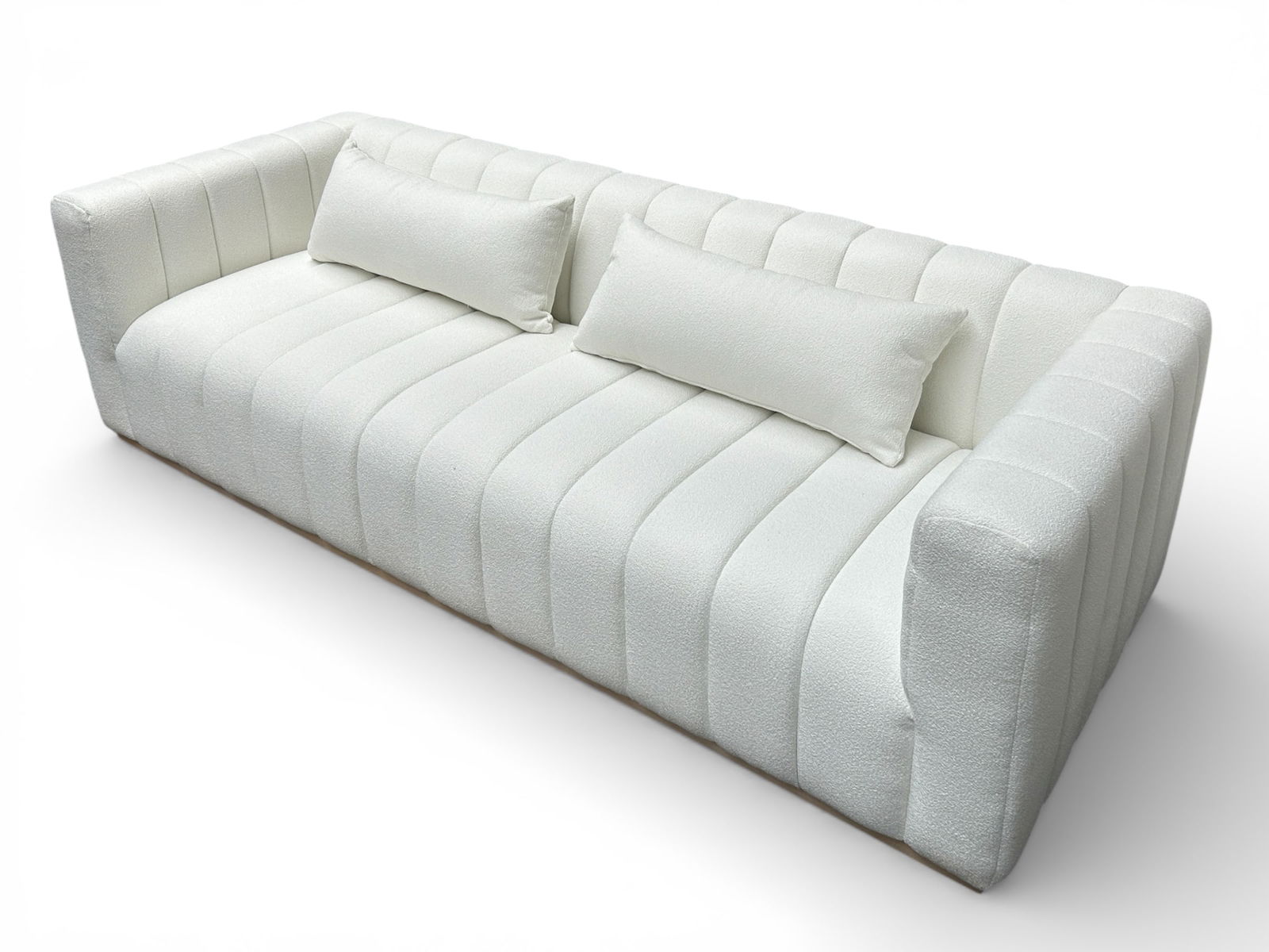 Elevarre Furniture "Andreeva" Sofa.: This is a white upholstered channel tufted sofa. The armrests and backrest are the same height. It has two large cushions or throw pillows. There are some dirt spots, especially along the bottom. It m
