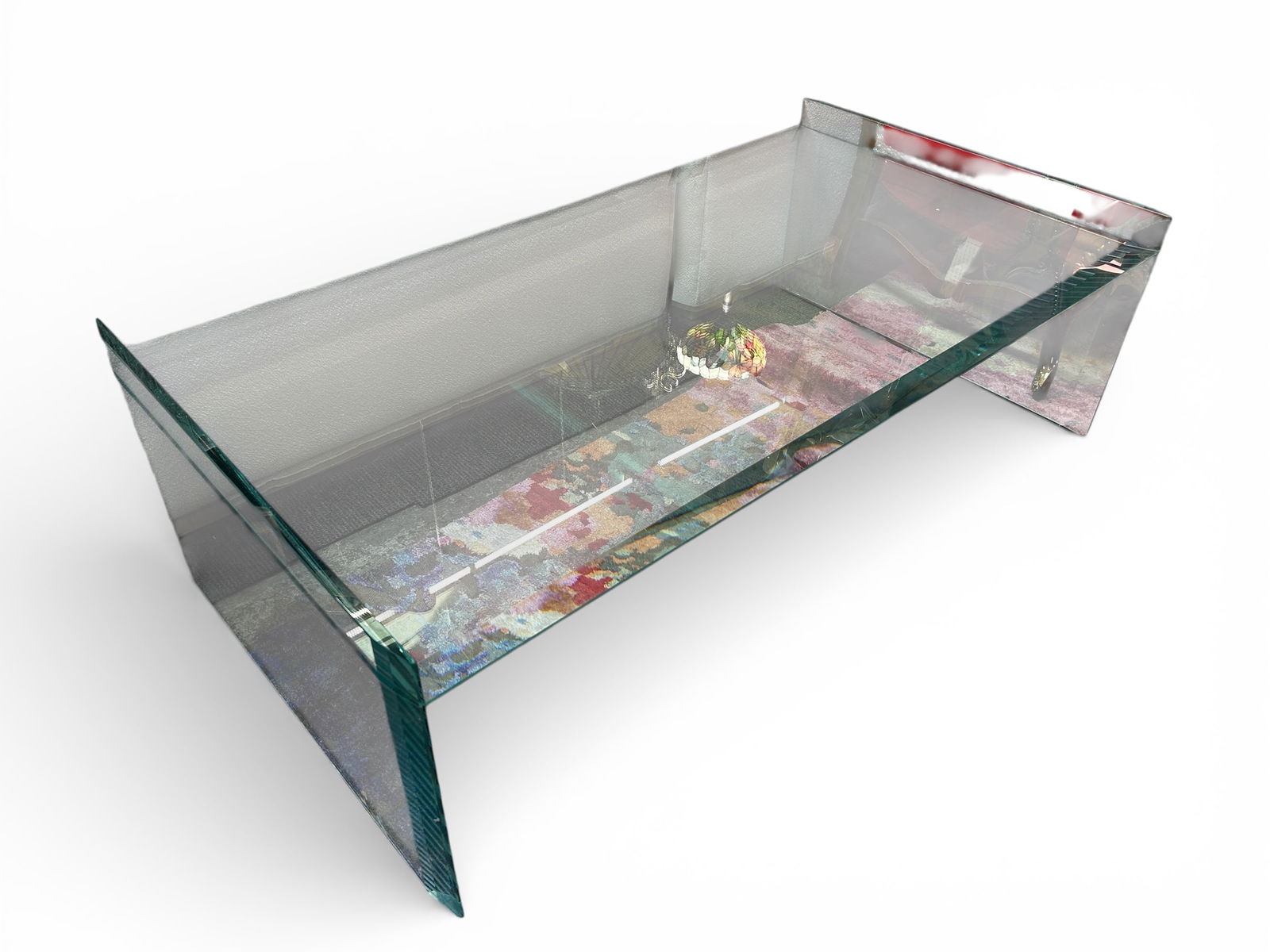 Bevelled Glass Modern Coffee Table.: This trestle style table is in good overall condition, with some scratches. It measures 50 1/2" wide, 27 1/2" deep, and 16" tall. Third-party freight shipping or personal pickup is required. Please