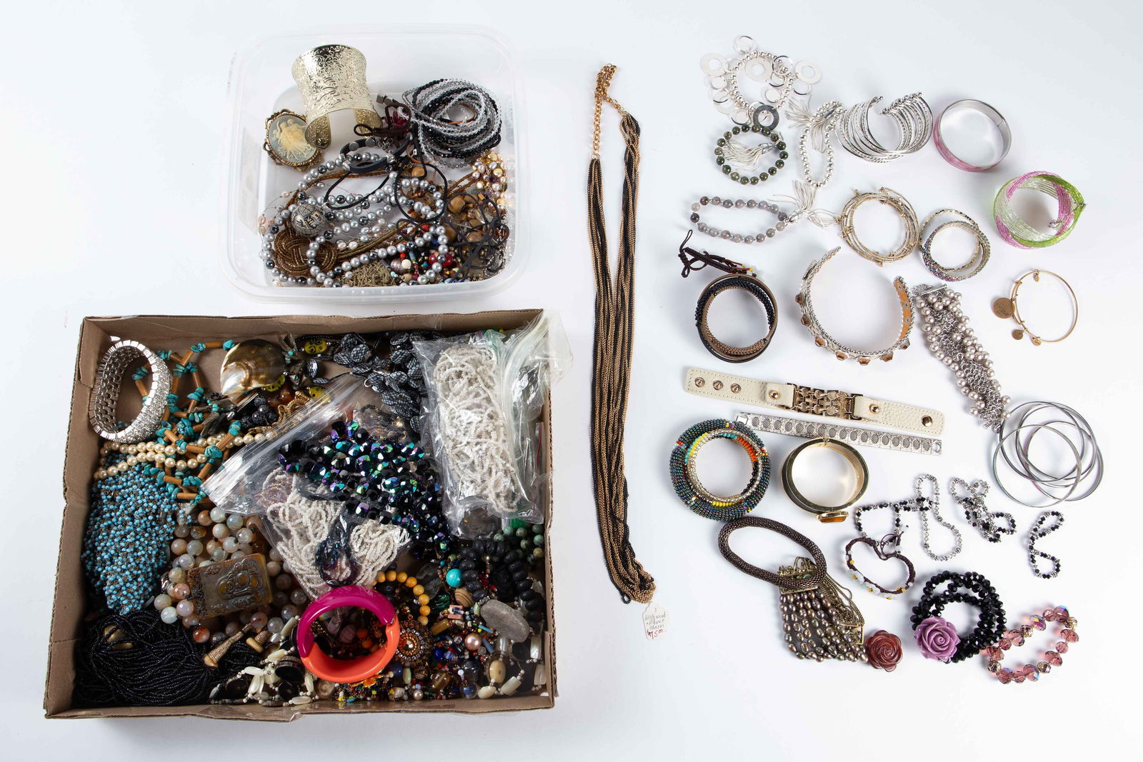 Lot of Costume Jewelry - Vintage, Cameo, Gemstones: The lot contains over 90 pieces of jewelry. There are necklaces, bracelets, a brass cameo brooch, and a few earrings and pendants. A few pieces are branded John Wind, Alex & Ani, Clara Beau, Diddi, an