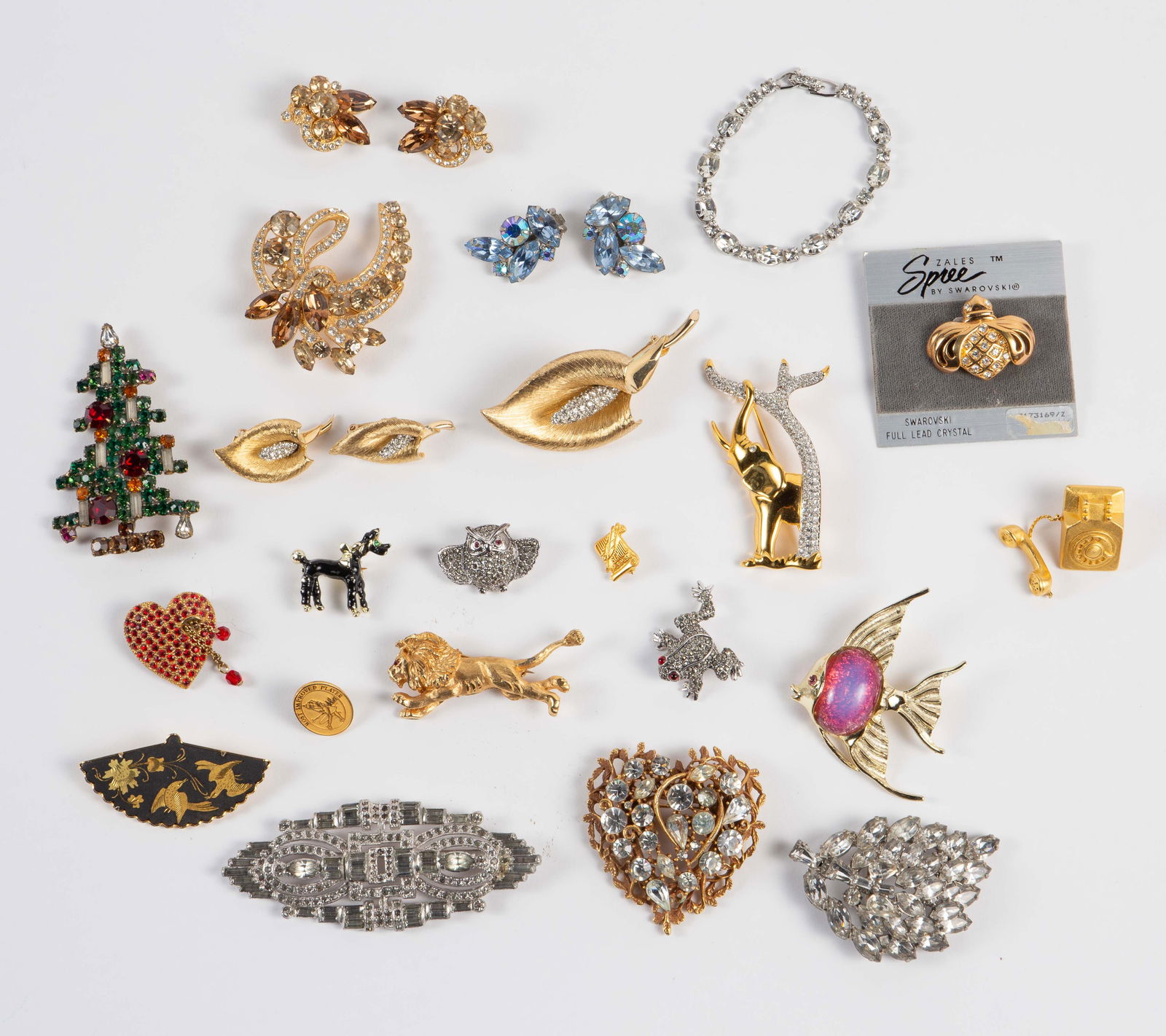 Costume Jewelry - Rhinestones, Weiss, Boucher, Etc: The lot contains 22 pieces of vintage costume jewelry. There are two 2 brooch and earring sets, 14 brooches, a bracelet, and a pair of earrings. The stand out pieces are a Boucher calla lily set, an E
