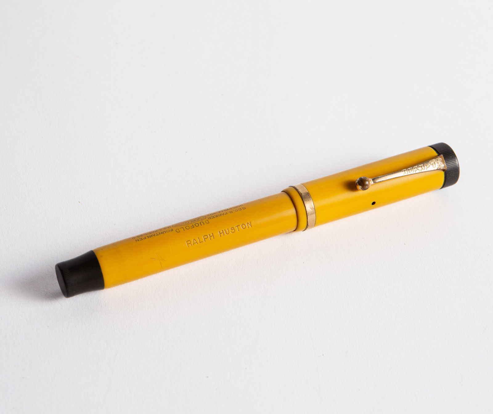 Parker Duofold Lucky Curve Fountain Pen w/ 14K Nib: The mandarin yellow Duofold Senior pen is branded and engraved with the previous owners name. The Parker #6 nib tested appropriately for 14K gold. The piece measures 5 3/8" long and up to 5/8" wide (n