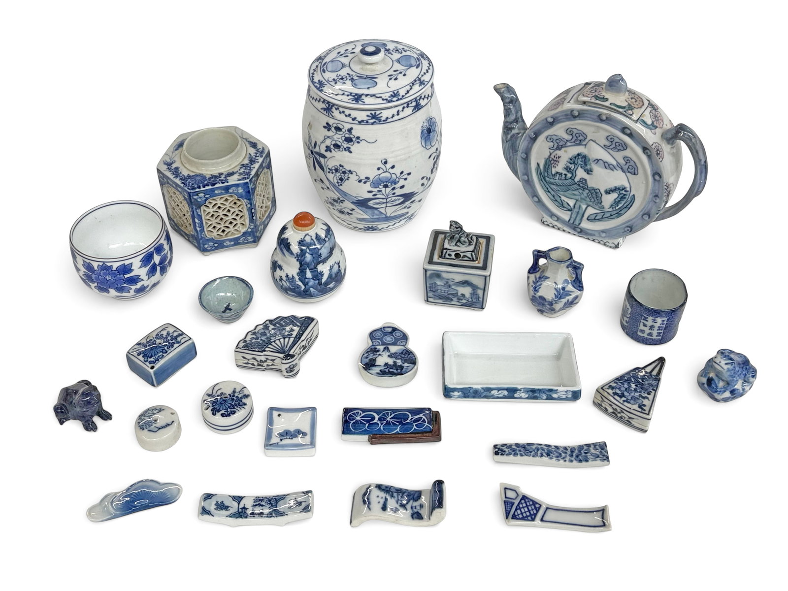 Asst. Asian Blue & White Porcelain Items & Lapis: The lot includes a jar, a teapot, a snuff bottle and various small items. Amongst the small items is a cute lapis lazuli carved frog. All of the items look to be in good overall condition. One piece i