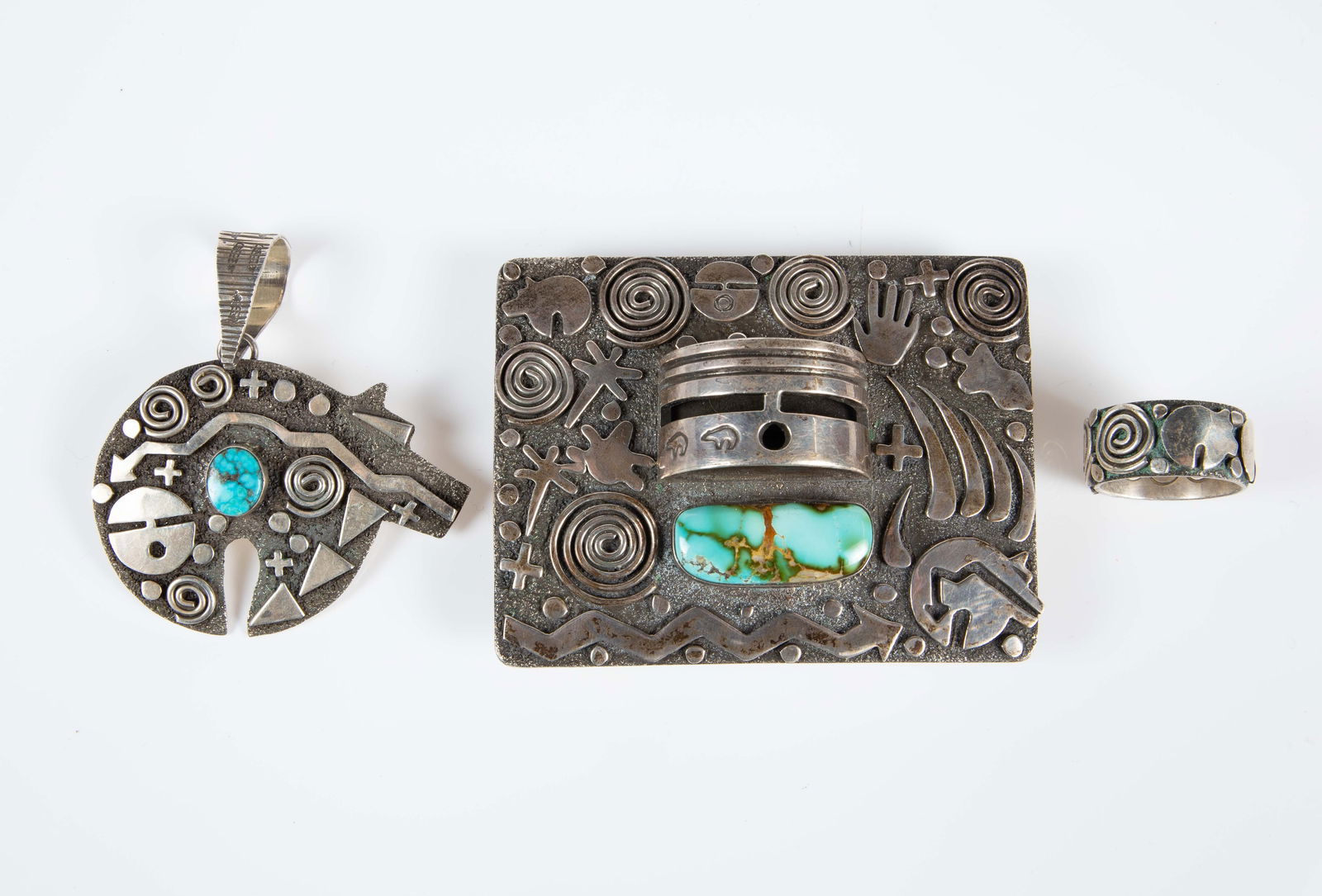 Alex Sanchez Petroglyph Jewelry Inc Kachina Buckle: The lot contains 3 pieces of sterling silver jewelry by Native American Indian artist Alex Sanchez, who is half Navajo and half Zuni. The lot contains a rectangular belt buckle with a turquoise stone