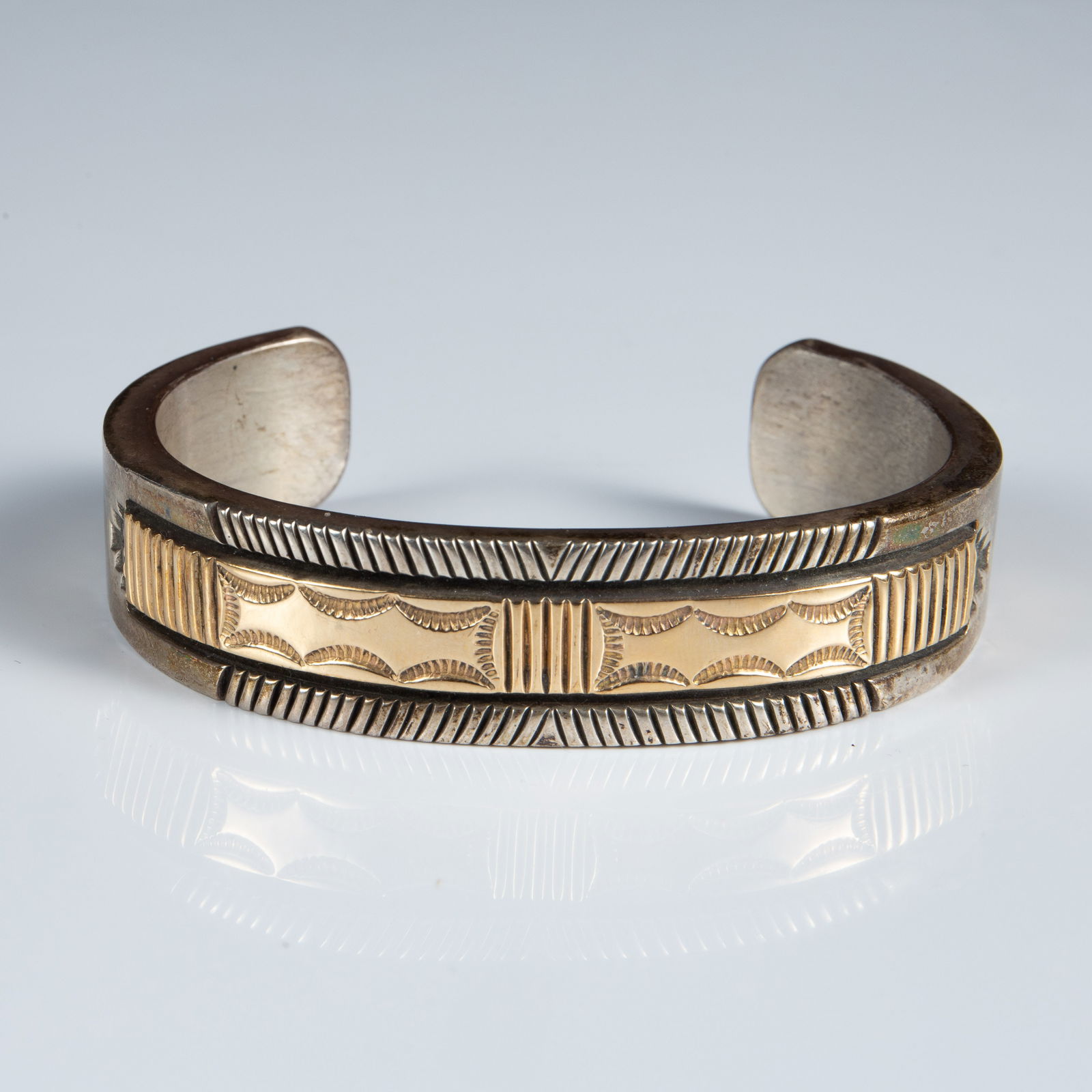 Bruce Morgan Sterling & 14K Gold Cuff Bracelet.: The bracelet is marked B. Morgan 14K Sterling on the inside. It measures 2 5/8" across the inside and 18mm wide. The heavy piece weighs 3.9 oz. Troy, or 122.7 Grams (including the solid sterling and