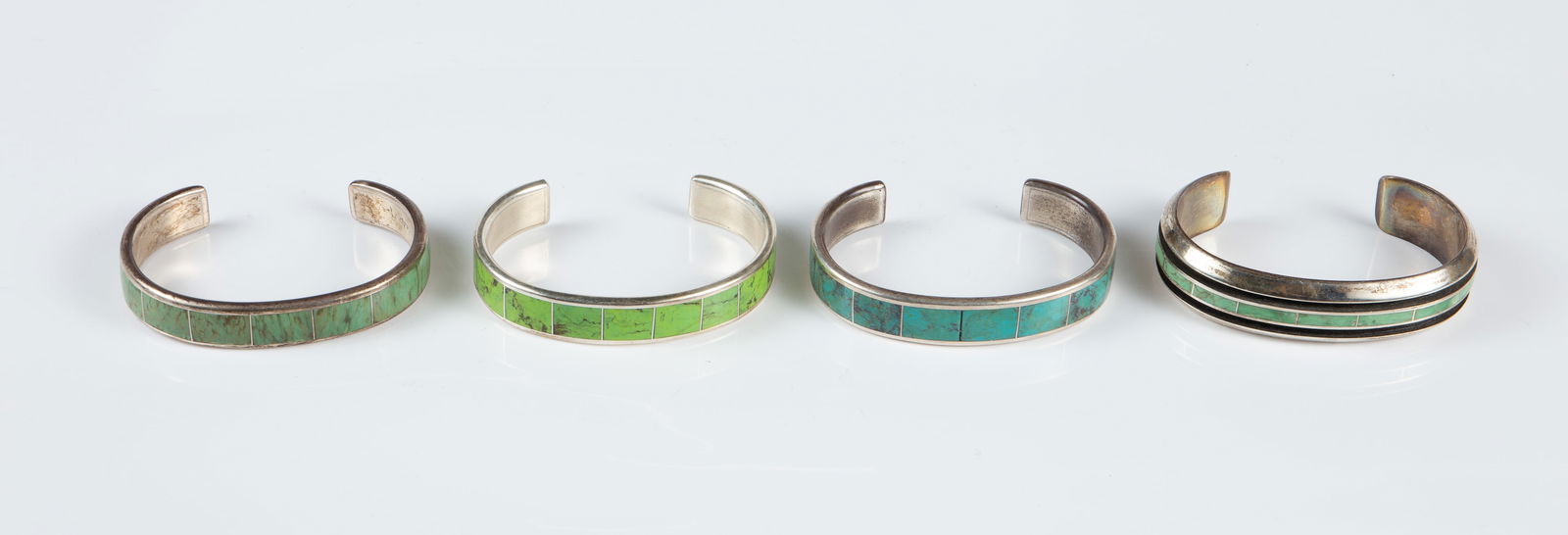 4 Loretto Zuni Sterling & Turquoise Cuff Bracelets: The lot contains 4 sterling silver and turquoise cuff bracelets by Native American Zuni jewelry maker Larry Loretto. They are all signed Loretto Sterling, along with Loretto's maker's mark on the