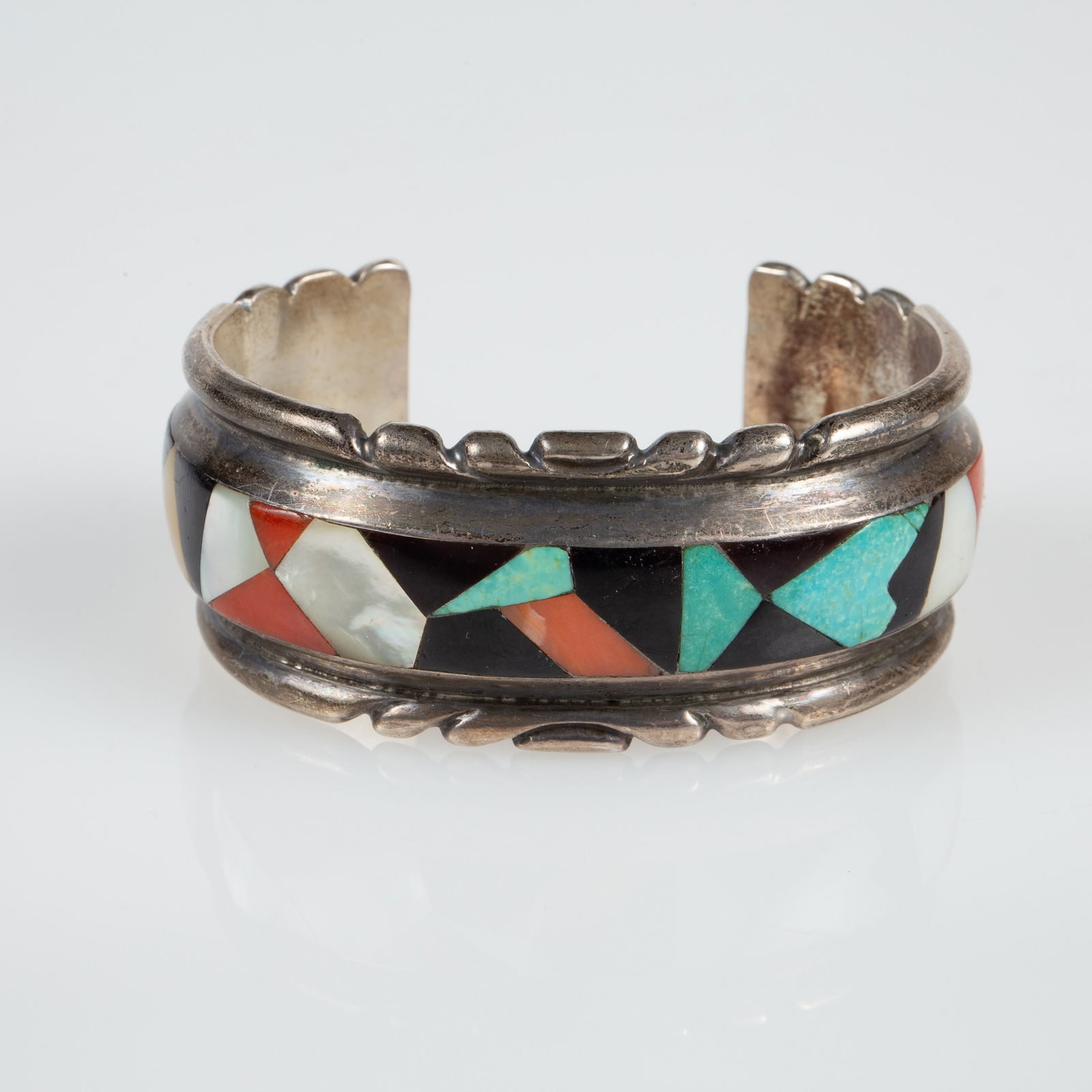 Zuni Wayne & Virginia Quam 925 Stone Cuff Bracelet: The Native American Indian Zuni cuff bracelet is marked W & V Quam Zuni on the inside. It tested appropriately for sterling silver. It features an inlaid multi stone mosaic design with turquoise,