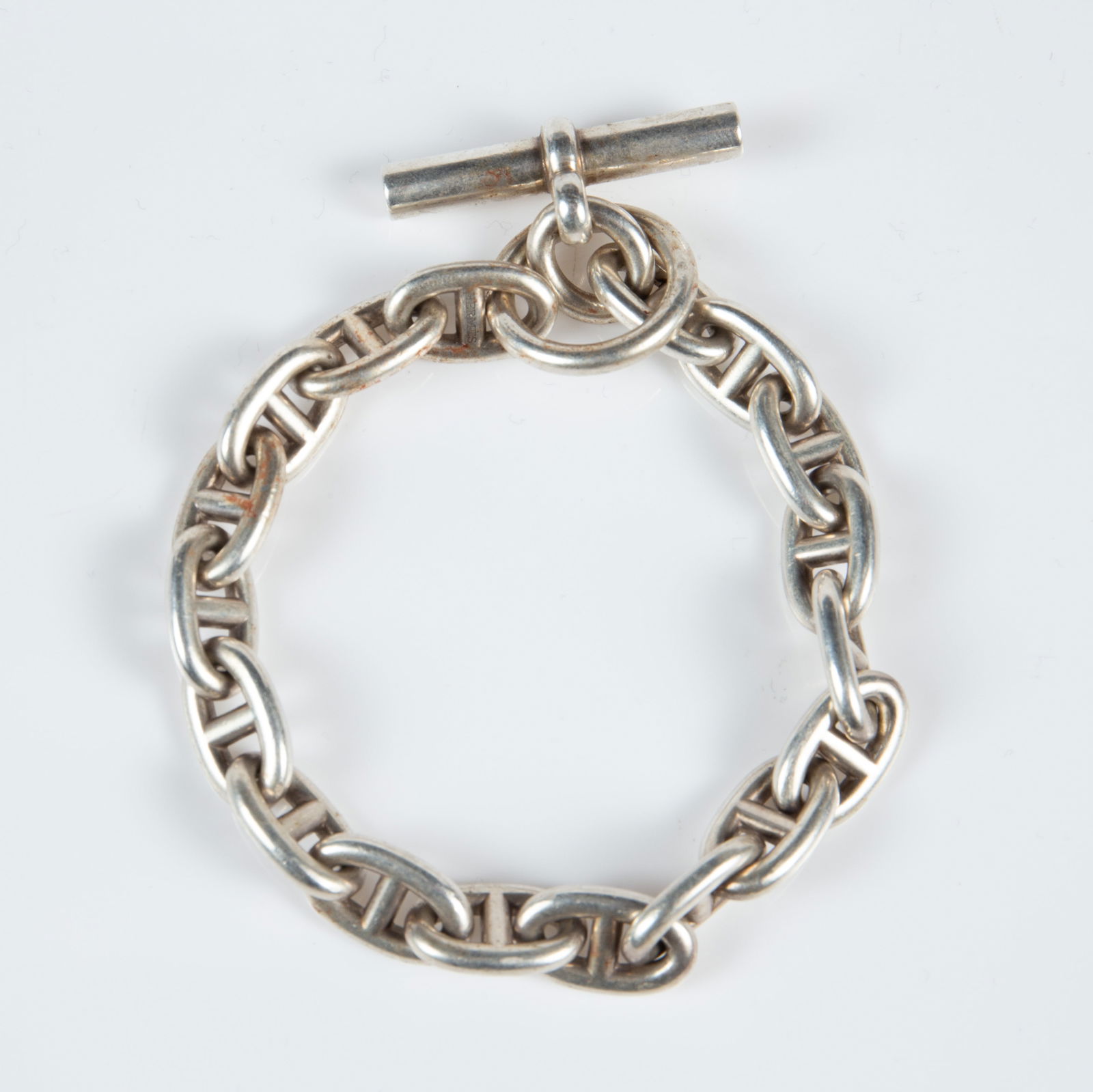 Hermes Chaine d'Ancre Sterling Bracelet.: The sterling silver bracelet is marked Hermes Ag925 Made in France 23AG580863 on one of the links. It measures 9", and the links measure 10mm in diameter. It weighs 2.1 Oz. Troy, or 65.4 Grams. There