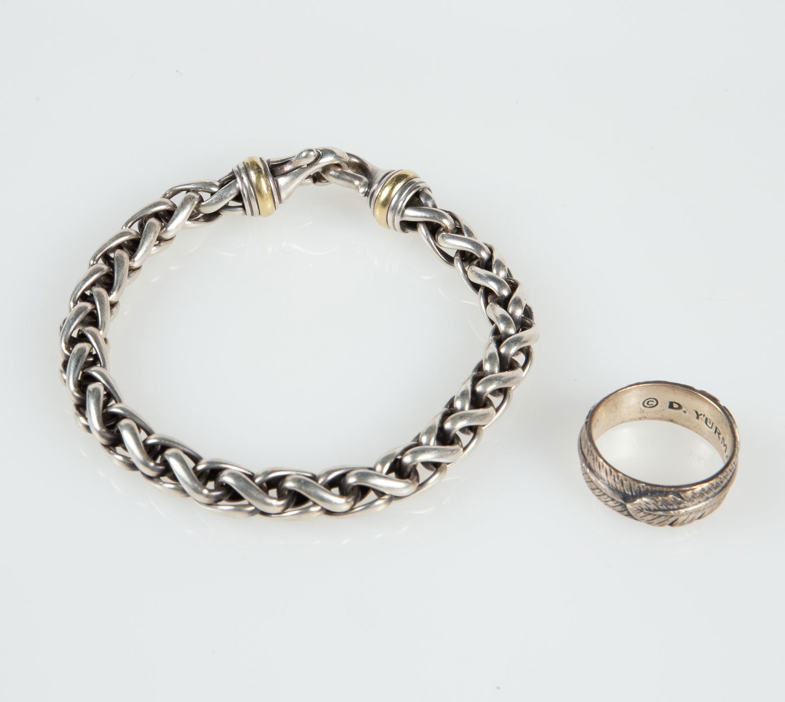 David Yurman Wheat Chain Bracelet & Feather Ring.: The lot contains 2 pieces of David Yurman sterling silver jewelry. The bracelet also has 2 small 14K gold bands near the clasp. The bracelet measures 8 3/4" long and 7/16" wide. The ring is a size 11