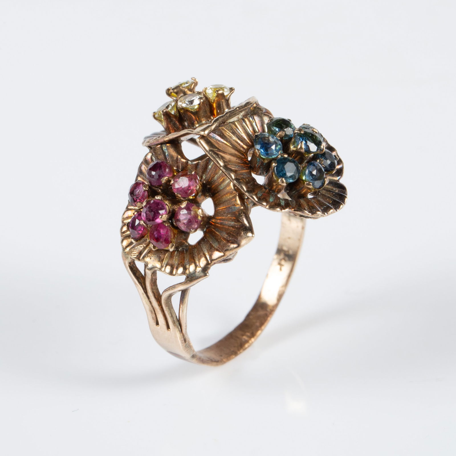 Vintage 14K Gold Ring w/ Gemstone Flowers.: The ring depicts 3 leaves, each with a flower comprised of 7 small round cut stones. The stones are pink, blue, and yellowish white. They may possibly be sapphires, rubies, and citrine. The ring is