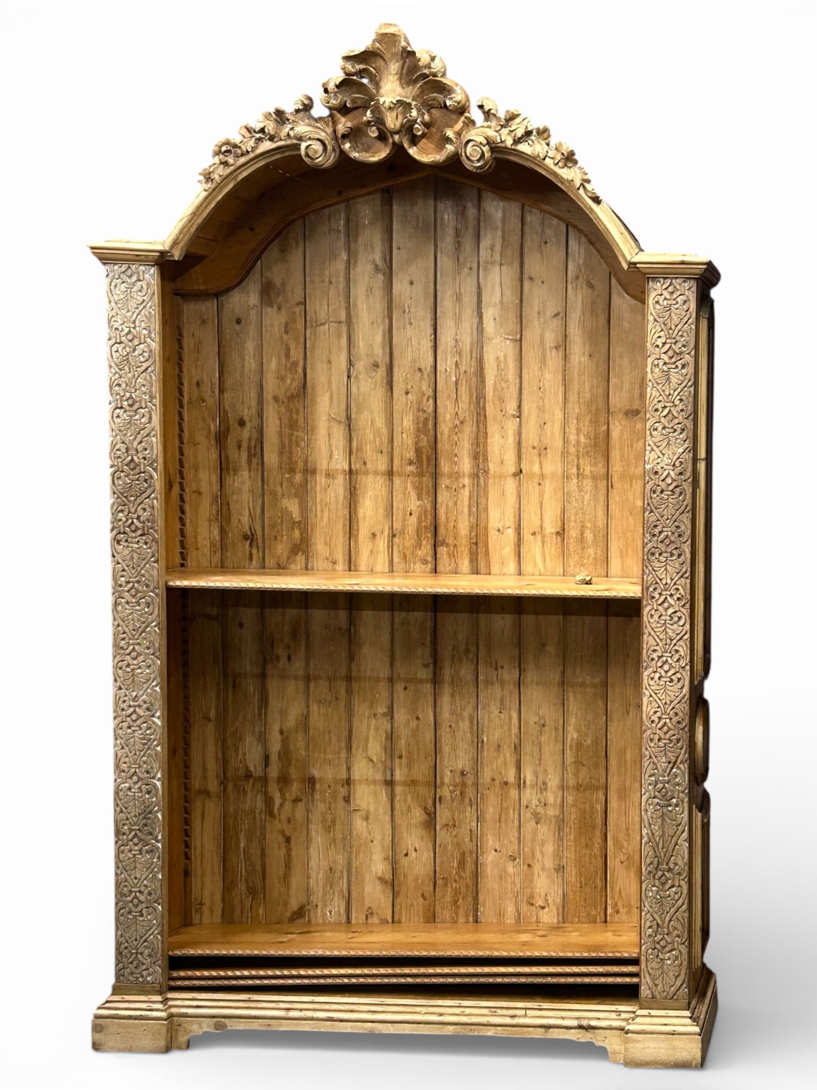 Large Carved Pine Bookcase.: This bookcase or shelving unit is constructed of pine, and possibly some oak. It has a large carved floral crest (a small piece has broken off and needs to be reattached), four adjustable shelves, a