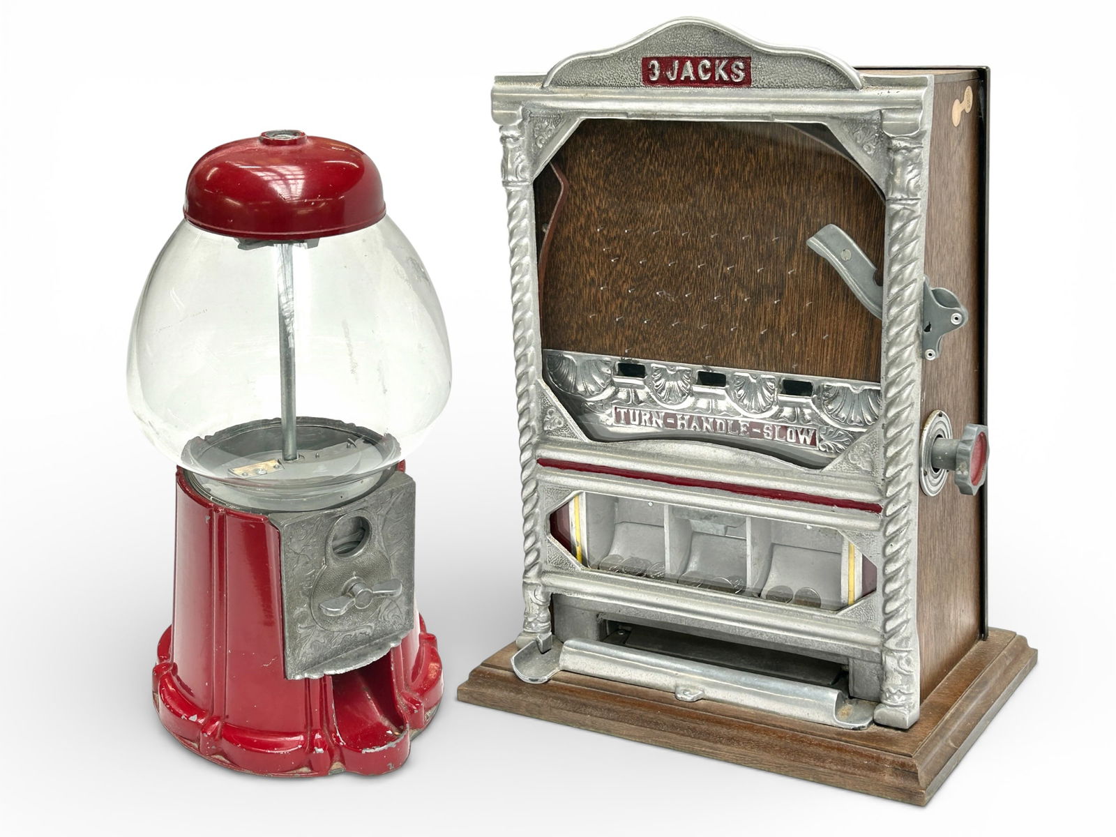 3-Jacks 10 Cent Trade Stimulator & Gumball Machine: The lot contains 2 items. There is a 3-Jacks counter top 10 cent or dime coin flip trade stimulator machine, and a red gumball machine by Carousel Industries. The trade stimulator, which does not come