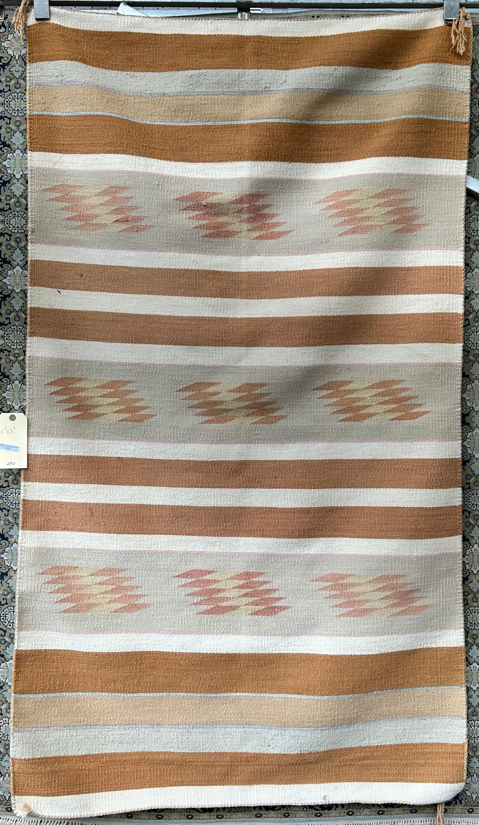 3' 2" x 5' 9" Light Earth Tone Navajo Rug.: The rug looks to be in good overall condition, but there is an indentation which looks like a slit in the upper left. It does not seem to go all the way through, though. It could possibly be an