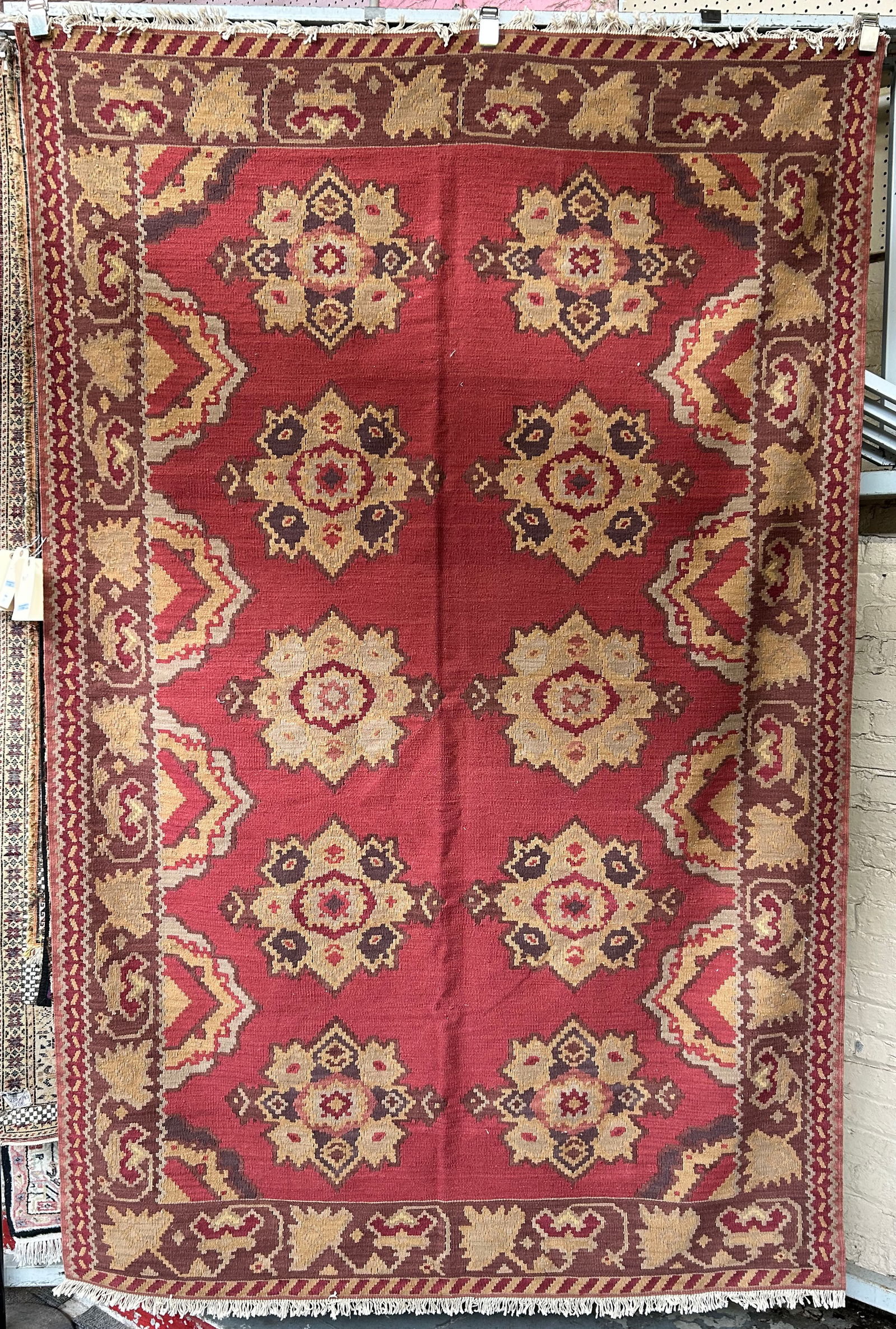5' 3" x 8' Red & Brown Kelim Rug.: The rug looks to be in good overall condition. In-house shipping is available for this rug. Please see our website regarding our in-house shipping procedures.