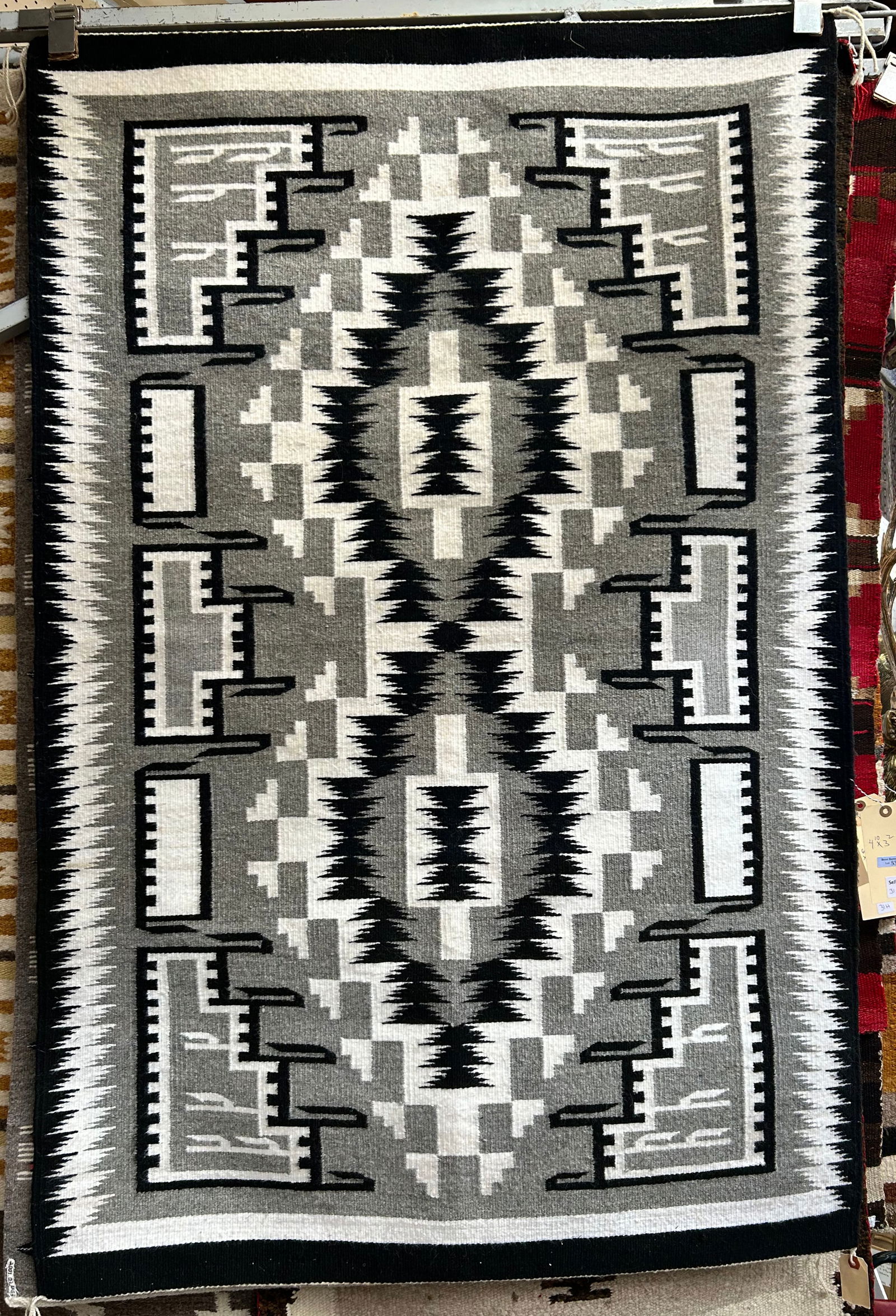 3' 2" x 4' 10" Black, White & Grey Navajo Rug.: This rug is in excellent condition, and is probably on the newer side. It still has a tag from Tobe Turpen's Indian Trading Company in Gallup, New Mexico, with a price tag of $1,395. In-house shipping