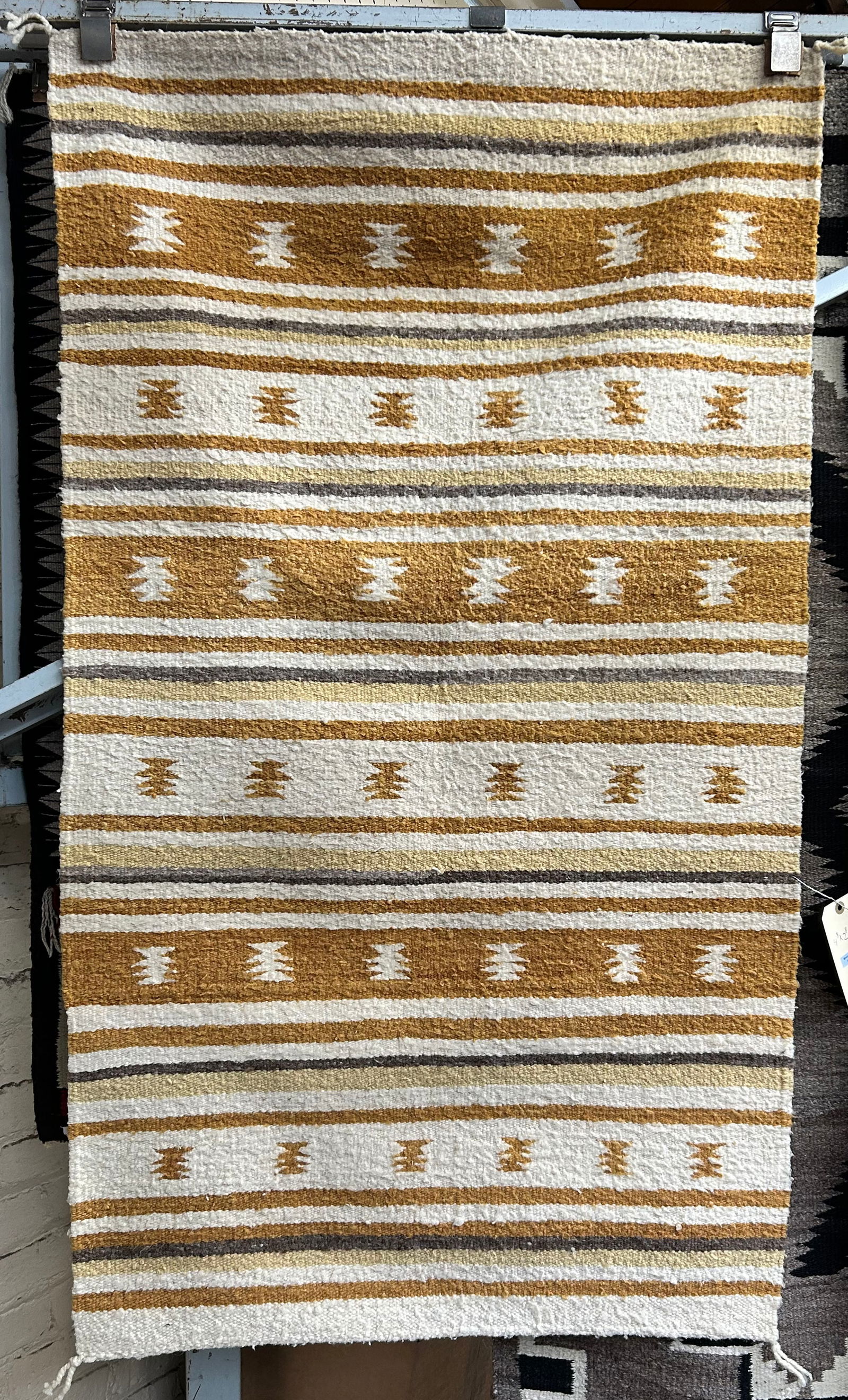 2' 8" x 4' 8" Beige & Gold Navajo Rug.: The rug looks to be in good overall condition. In-house shipping is available for this rug. Please see our website regarding our in-house shipping procedures.
