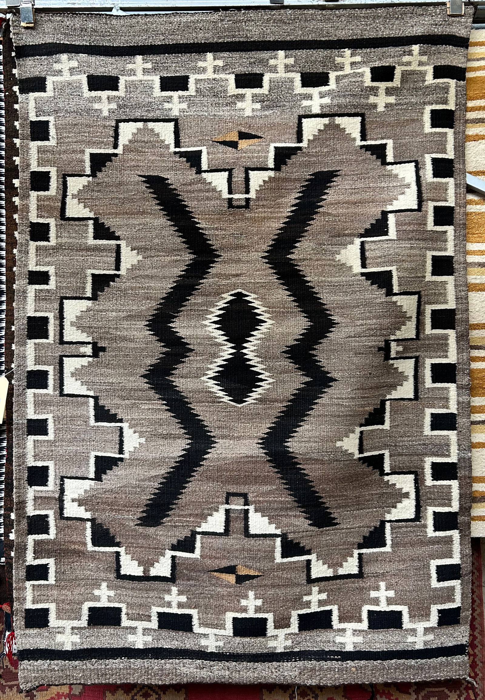 4' x 5' 10" Eye Dazzler Navajo Rug.: The has a tiny bit of wear along the edges, but is in good overall condition. In-house shipping is available for this rug. Please see our website regarding our in-house shipping procedures.