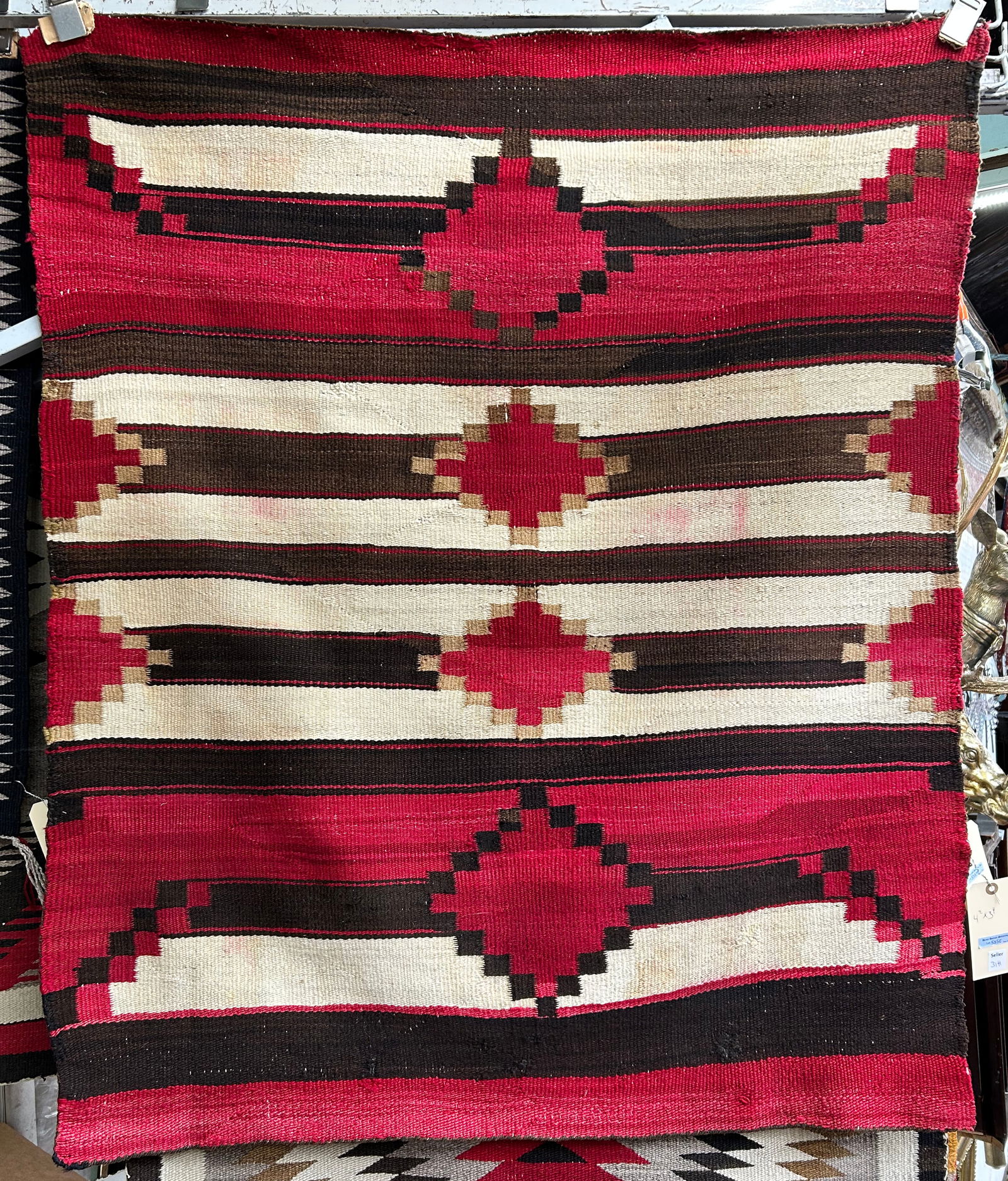 3' 4" x 4' 2" Vintage ? Navajo Rug.: The rug has a stain and what looks to be some repairs. In-house shipping is available for this rug. Please see our website regarding our in-house shipping procedures.