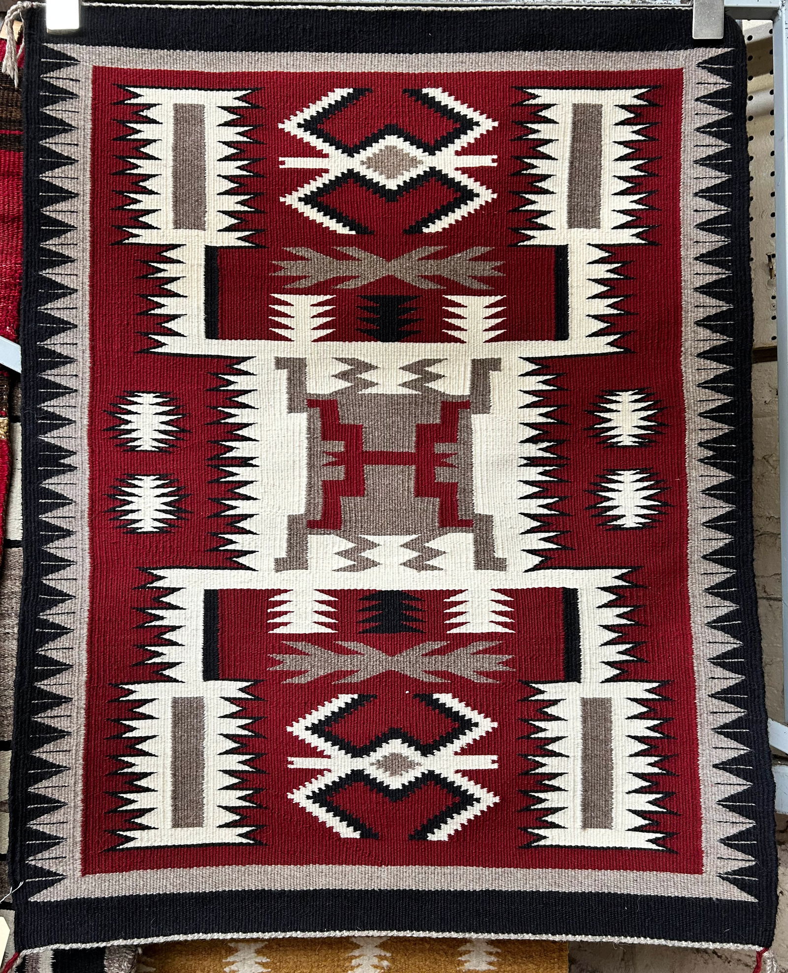 2' 6" x 3' 1" Eye Dazzler Navajo Rug.: The rug looks to be on the newer side. It is in excellent condition. In-house shipping is available for this rug. Please see our website regarding our in-house shipping procedures.