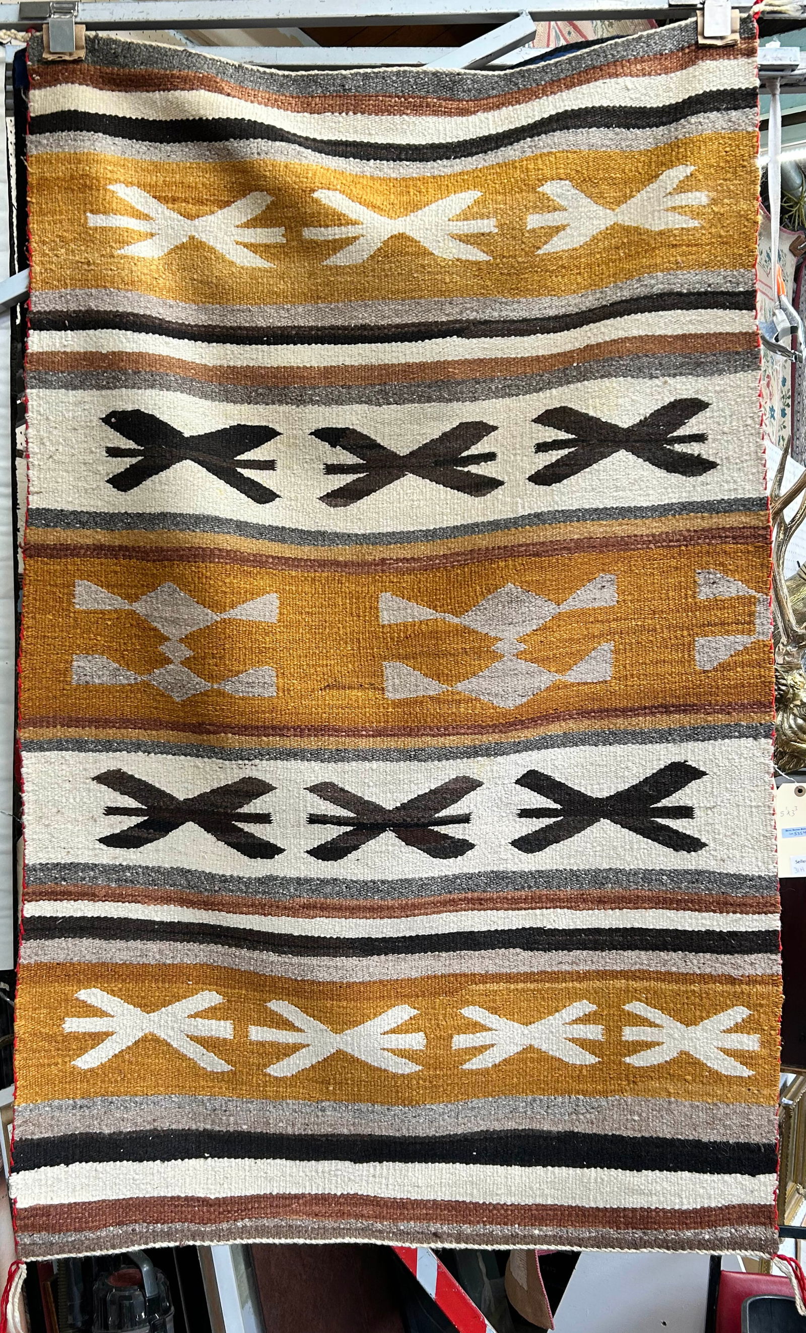 3' 3" x 5' 1" Vintage Navajo Rug.: The rug looks to be in good overall con, with slight wear on the edges. In-house shipping is available for this rug. Please see our website regarding our in-house shipping procedures.
