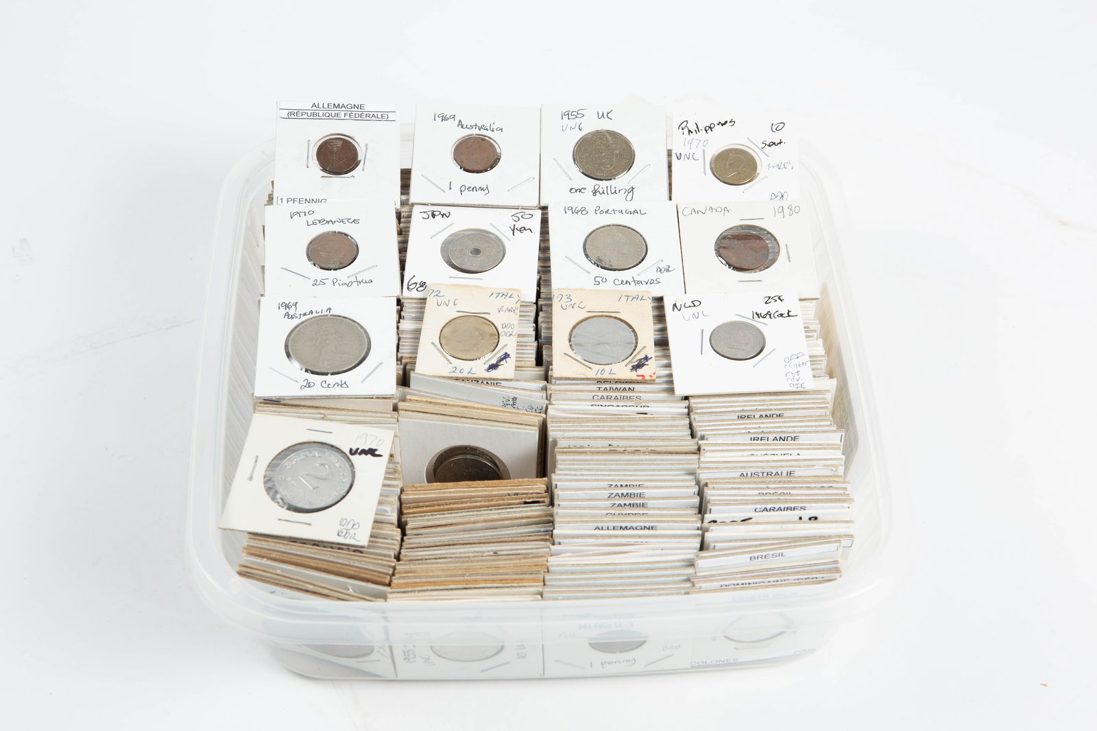 Over 300 Vintage International Coins.: The lot contains over 300 vintage coins from around the world, protected in card stock sleeves. Some of the countries observed are Venezuela, Taiwan, Uruguay, Japan, Holland, South Korea, China,