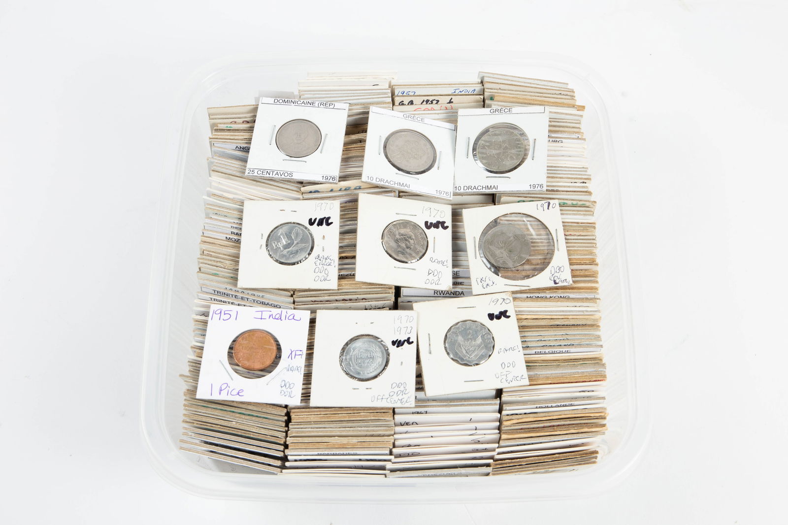 Over 300 Vintage International Coins.: The lot contains over 300 international coins in card stock protective sleeves. A few pieces are likely silver. Some of the countries observed are Spain, Great Britain, the Philippines, Ceylon,