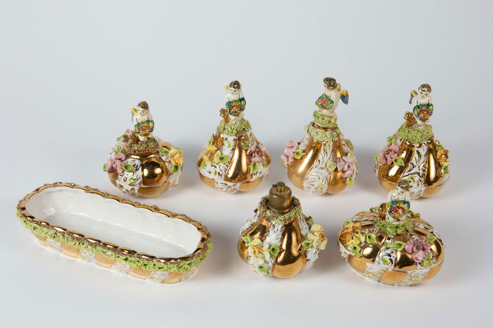 Set of Italian Capodimonte Porcelain Vanity Items.: This set has an angel or cherub motif. There are some nicks and areas with paint loss, but overall, the lot looks to be in good condition. The largest item measures 10 1/8" x 4 1/4" x 1 3/4". The smal