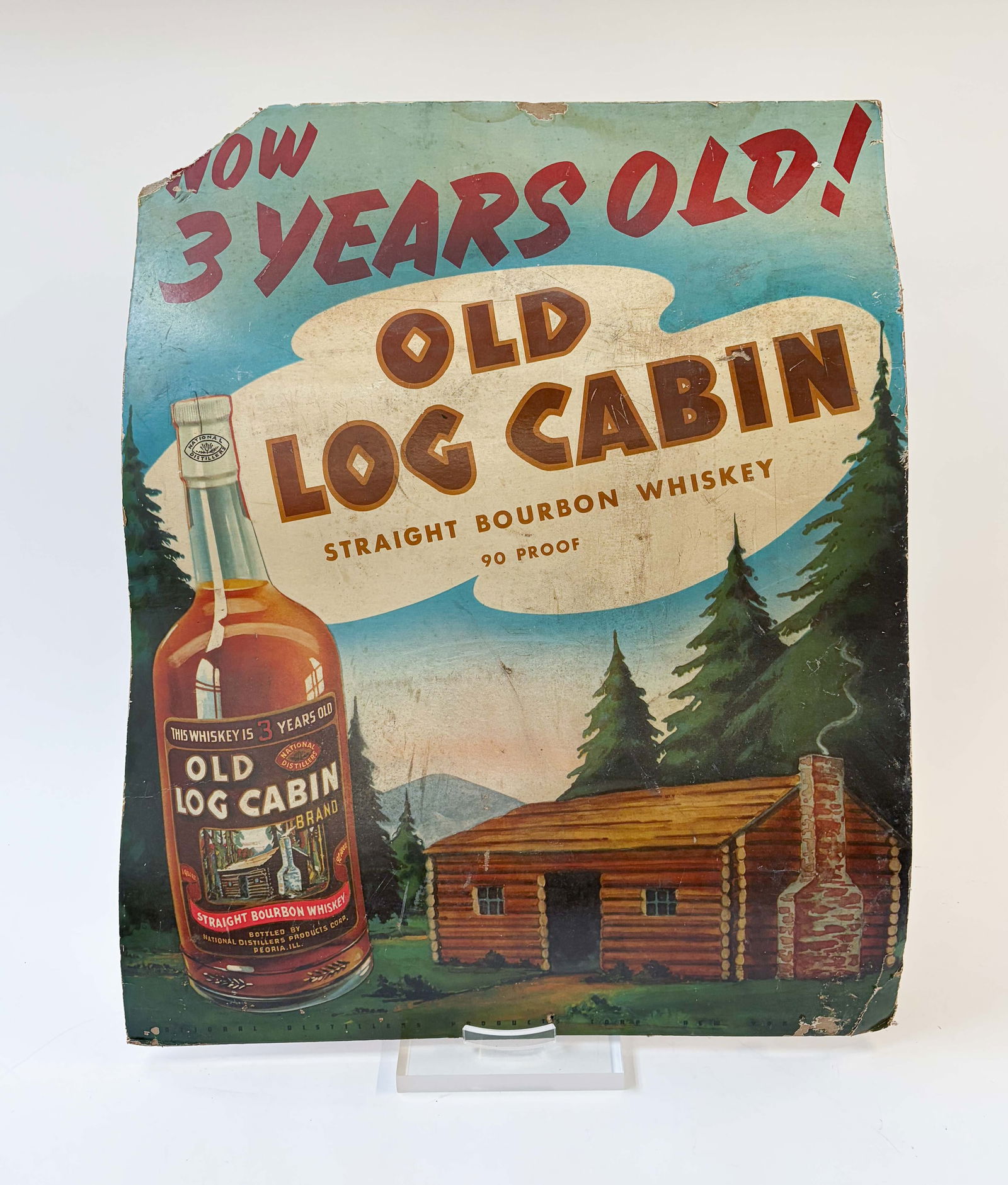 Old Log Cabin Straight Bourbon Whiskey Sign.: This cardboard store display sign has some signs of surface wear, and a missing top left corner. It is also a bit warped. It measures 32 1/2" x 26 1/8" x 1/4". In-house shipping is available. Please s