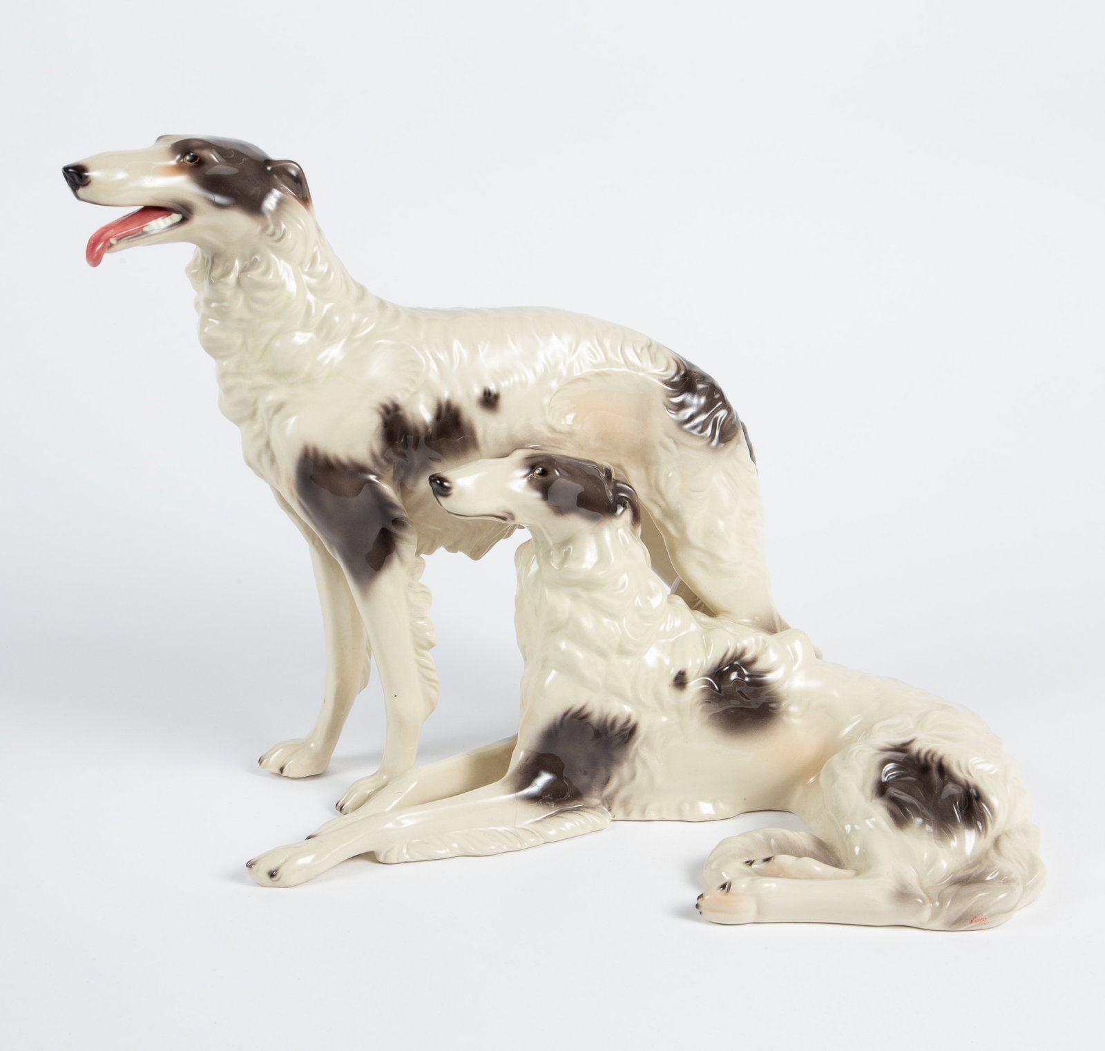 Steffl Fayencen Porcelain Pr. Greyhounds Sculpture: The glazed porcelain sculpture is marked Steffl Fayencen Wein Hand Decorated Made in Austria on the underside. The figural sculpture features 2 greyhound dogs. It measures 11 3/4" tall, 16" wide, and 