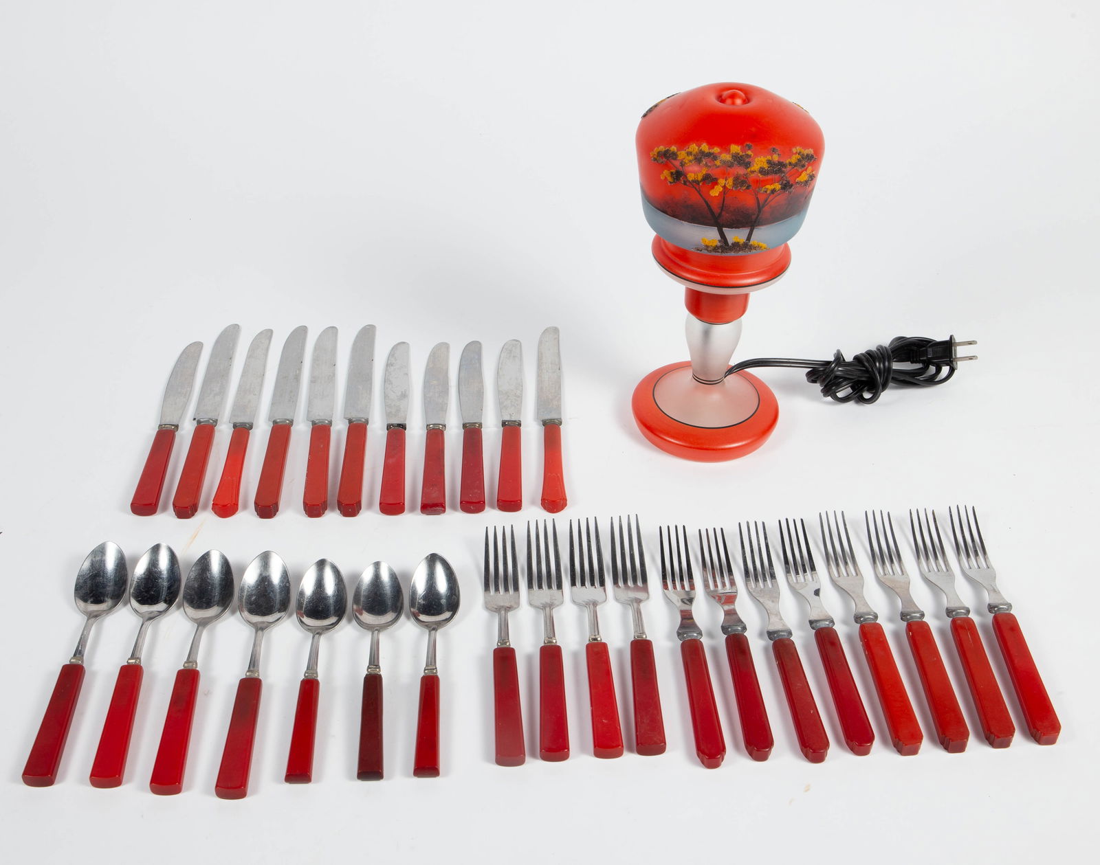 Lot: Boudoir Lamp, Flatware w/ Bakelite Handles.: The glass boudoir lamp is stamped, "Made in Czechoslovakia". It looks to be in good cosmetic condition. With the shade on, it measures 5" x 5" x 10 1/2". The flatware looks to be made up of two