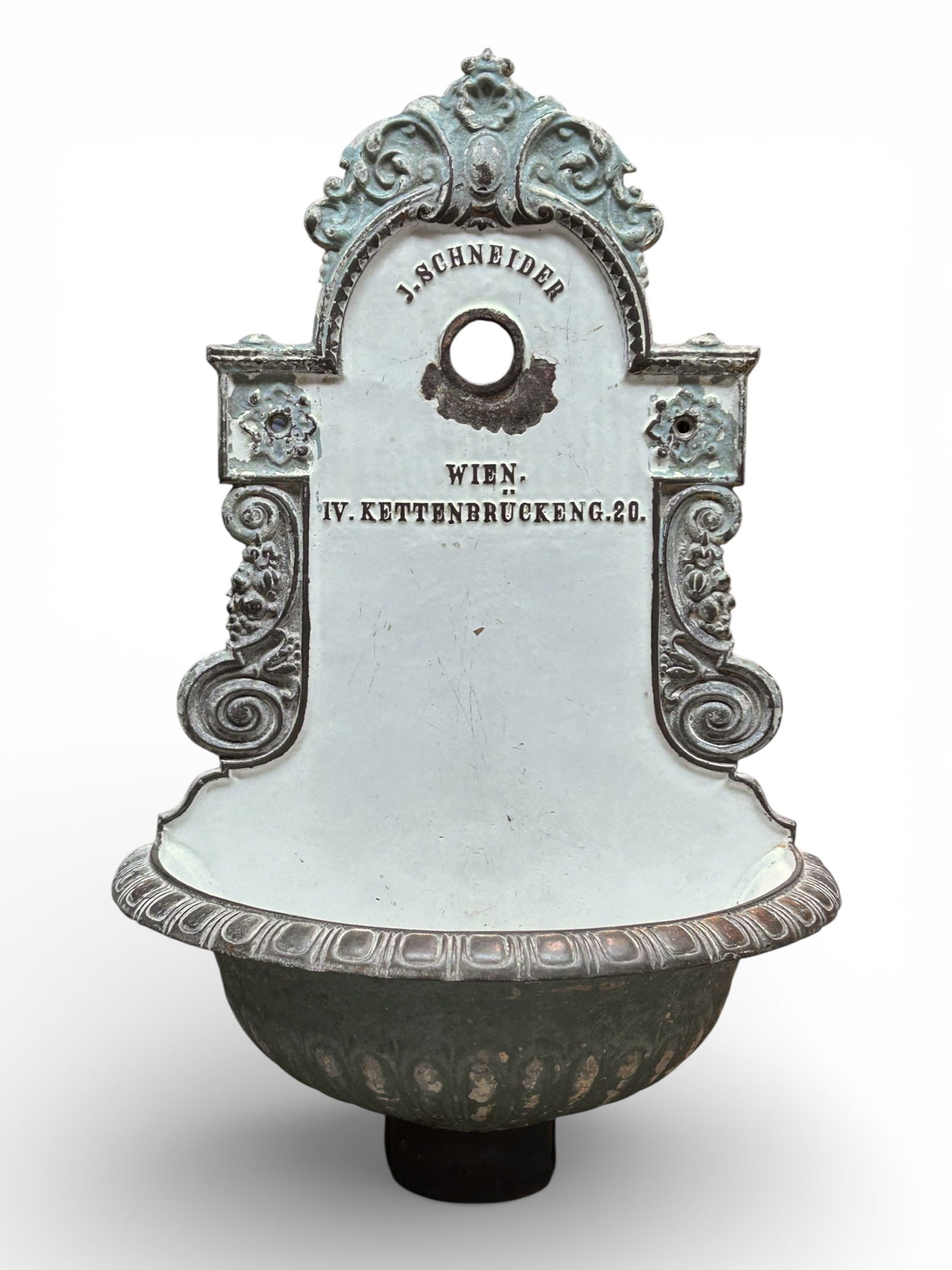 Cast Iron Enameled Water Fountain Lavabo, Vienna.: The antique wall mounted public water fountain or lavabo is mostly enameled in white, and has ornate decorations on the sides and top. It is labeled J. Schneider, along with an Austrian address for it